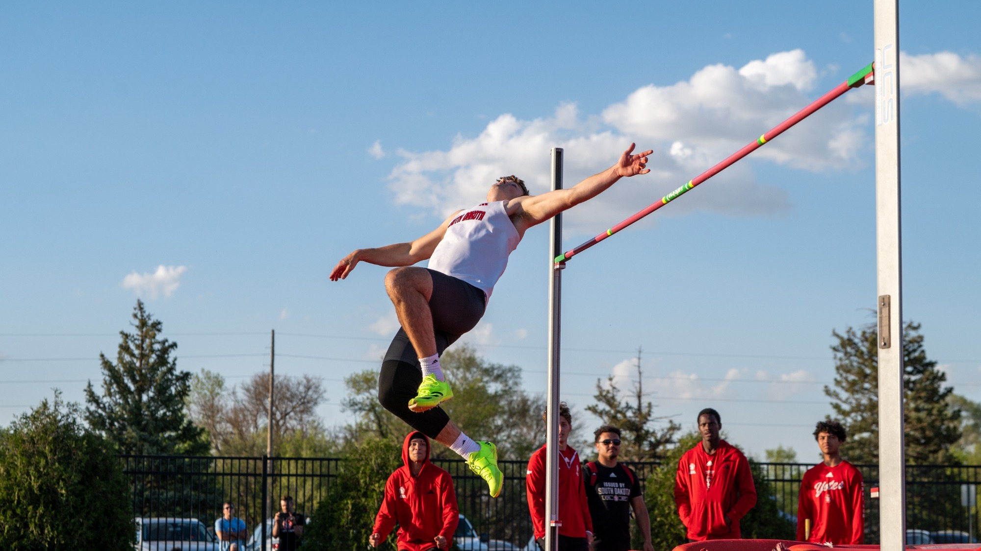 Landon Olson attempts to clear the high jump bar at a meet at Lillibridge Track Complex