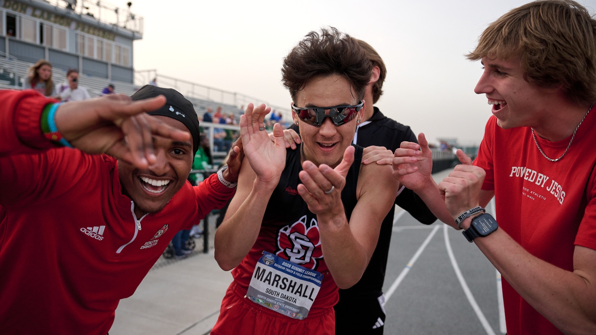 Piercze Marshall celebrates with teammates after placing second in the Summit League's 10,000-meters race