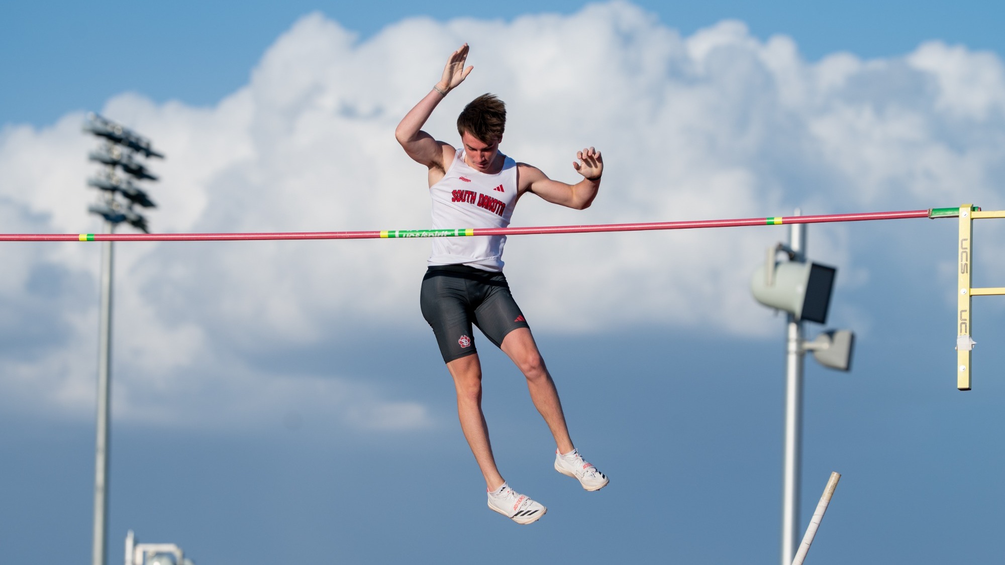 Caelan Harland clears the pole vault bar during a home meet earlier this season