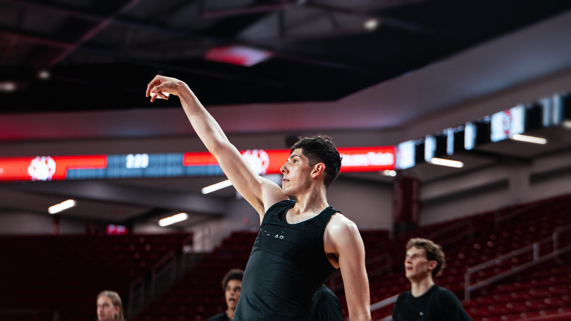 Melo Sanchez holding his follow through during a men's basketball summer practice 
