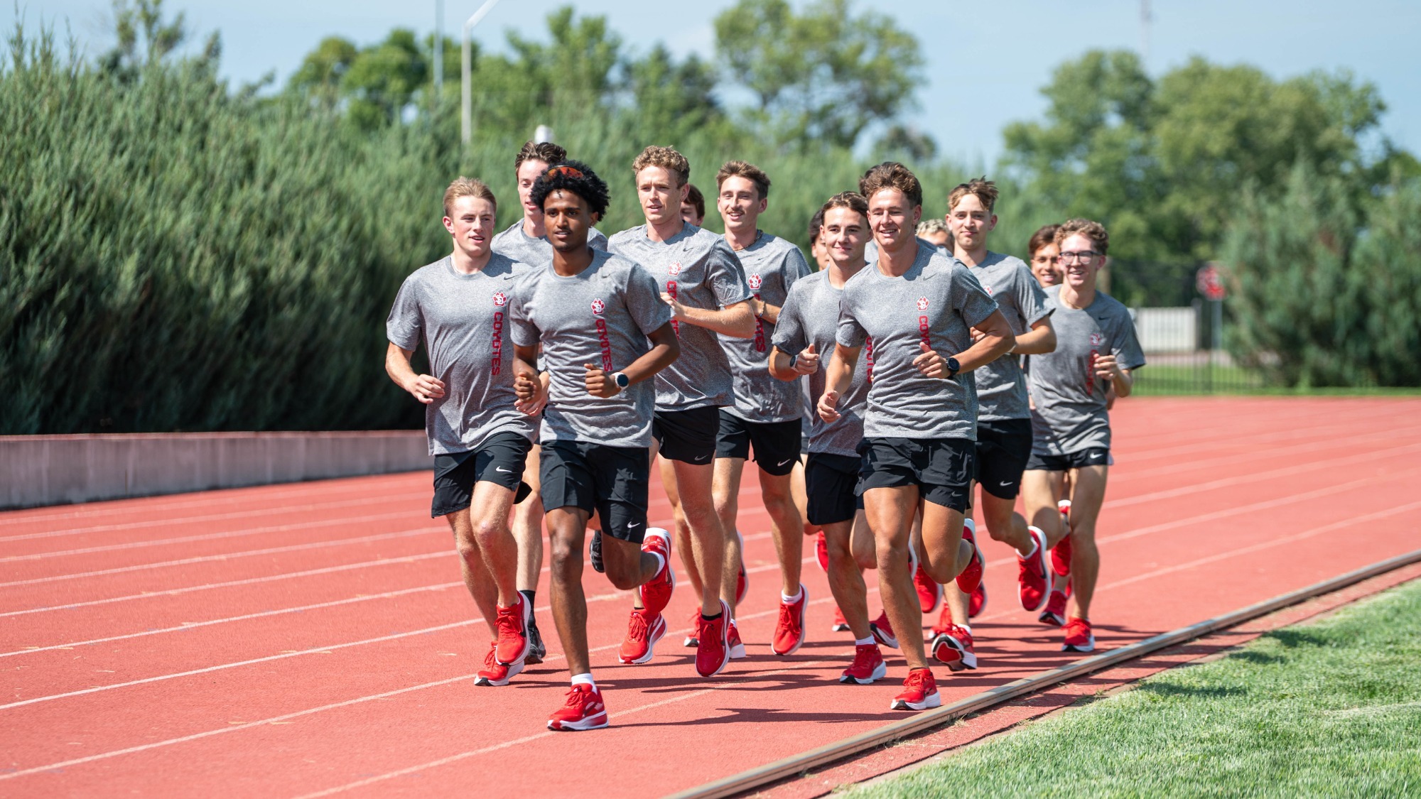 The men's cross country team does warm up laps at the Lillibridge Track Complex