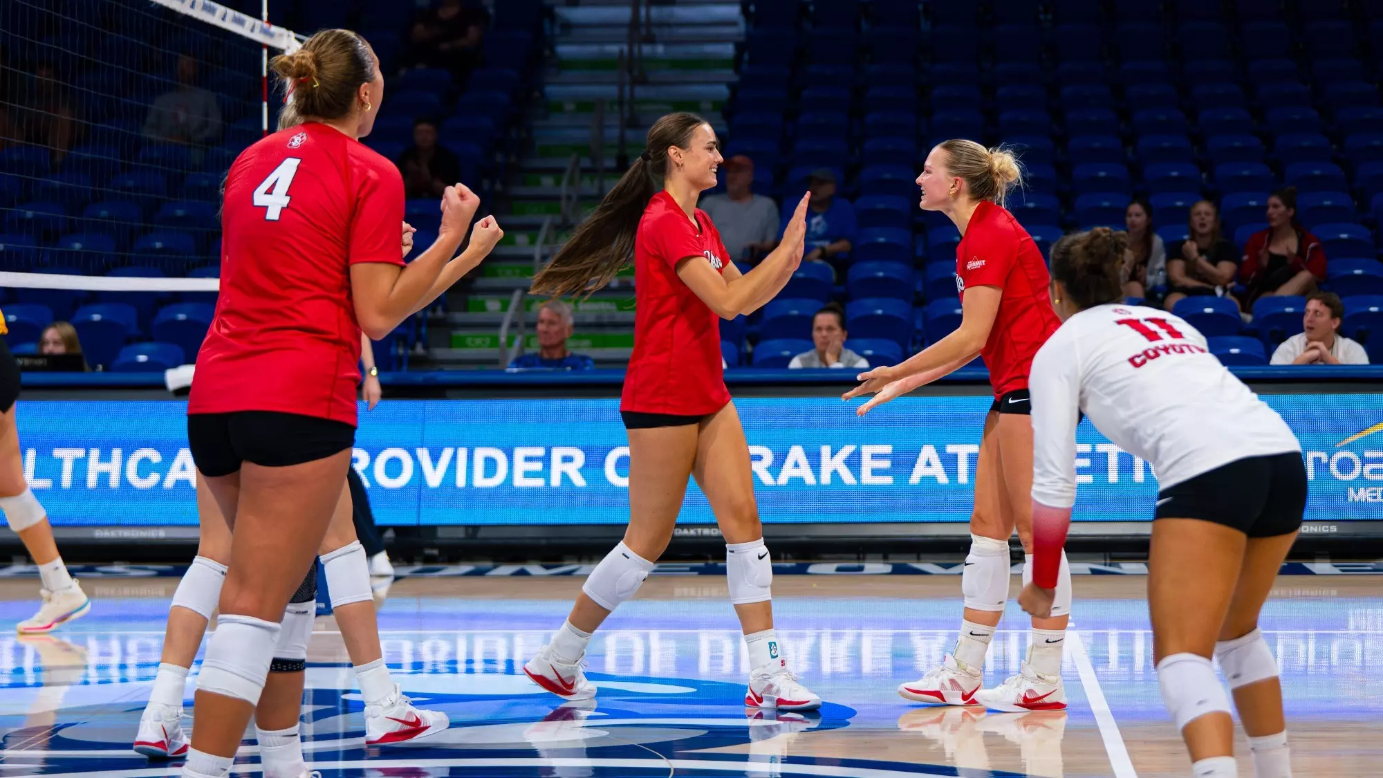 Audrey Nelson and Avery Van Hook high fiving after a point against Milwaukee 2026