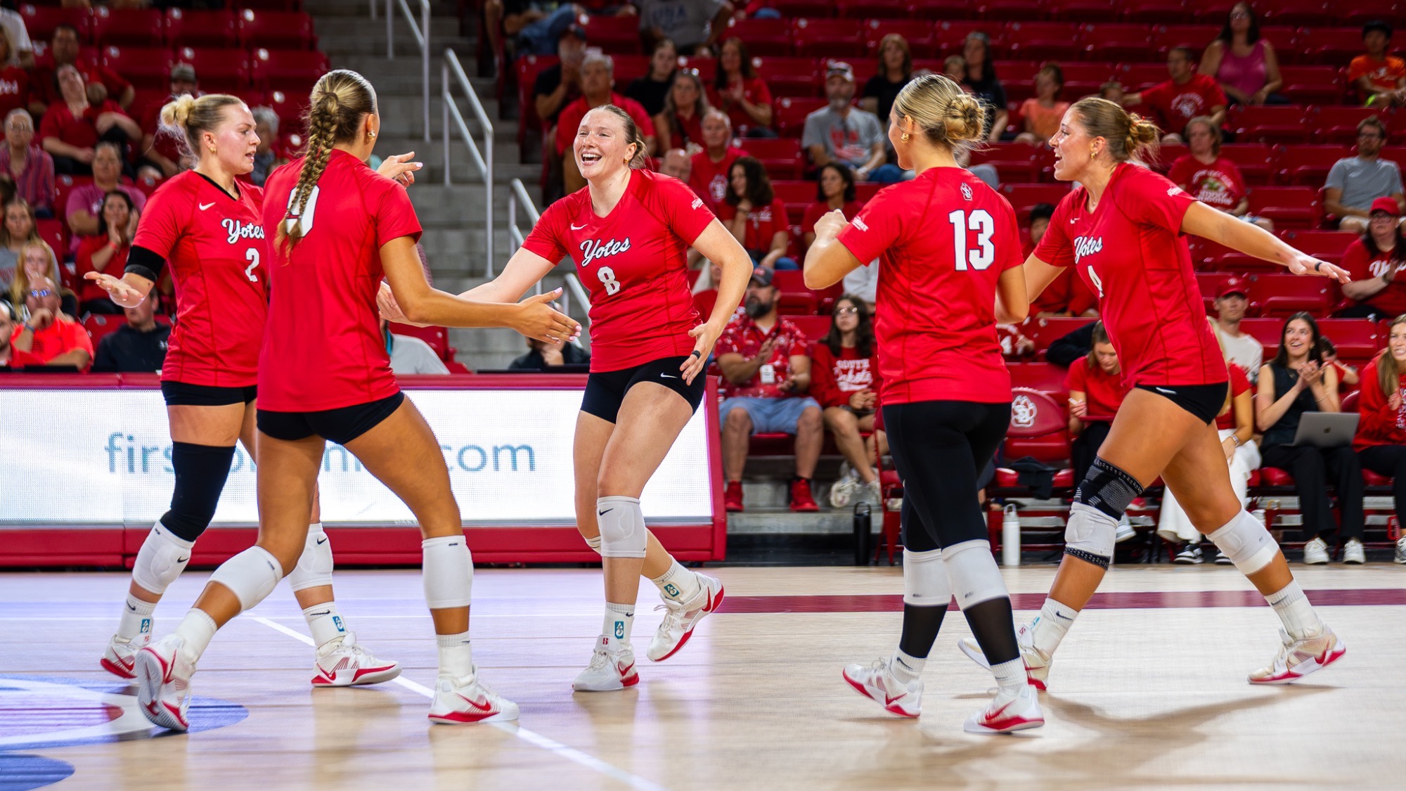 Volleyball team celebrating a point against UNI