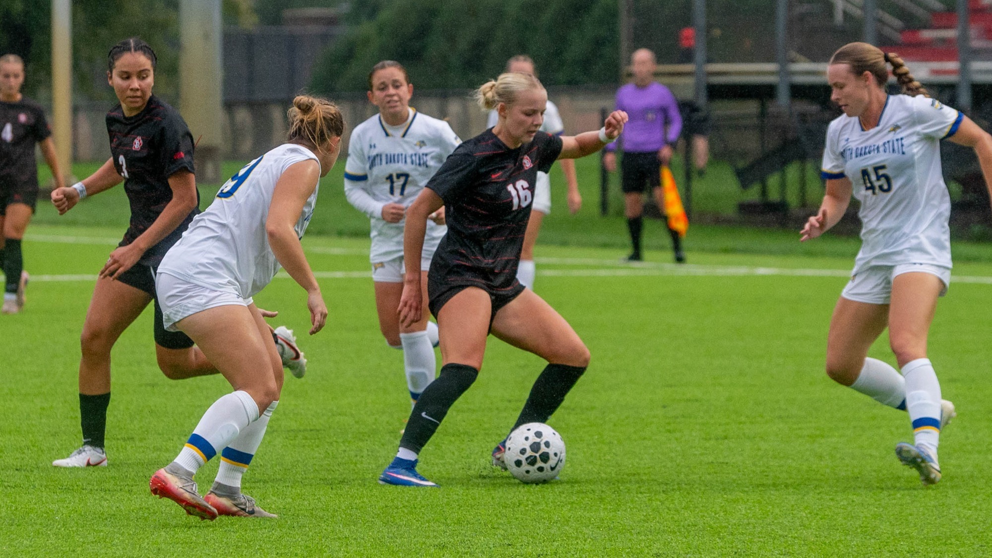 Brooklynn Pollmiller dribbles around SDSU defenders.