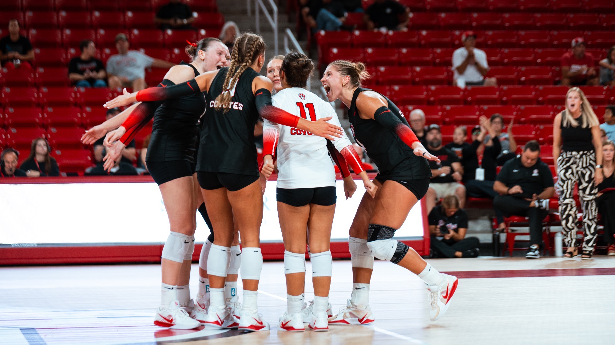 VB team huddle celebrating a point 2026