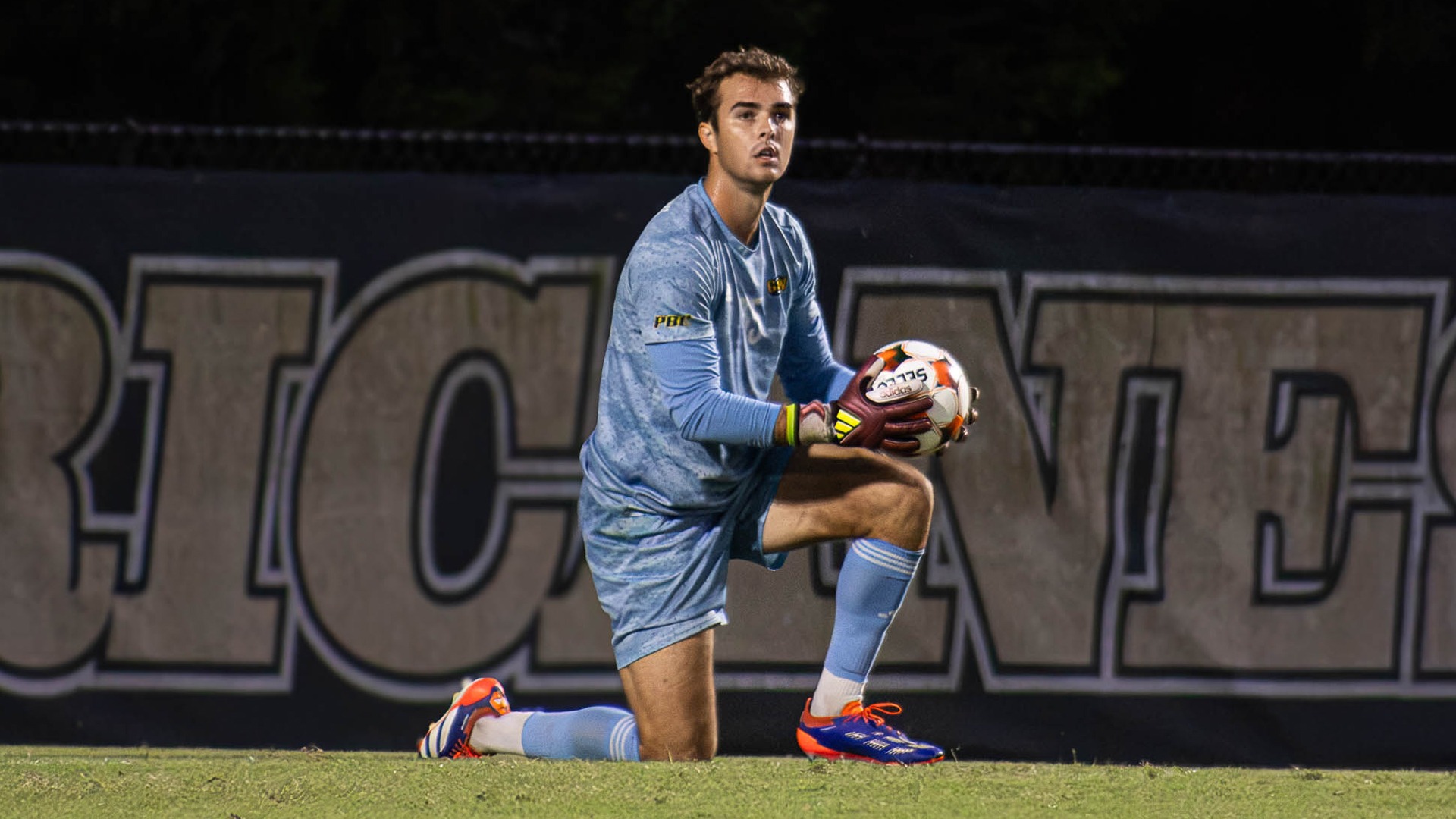GSW goalkeeper on one knee with ball in hand