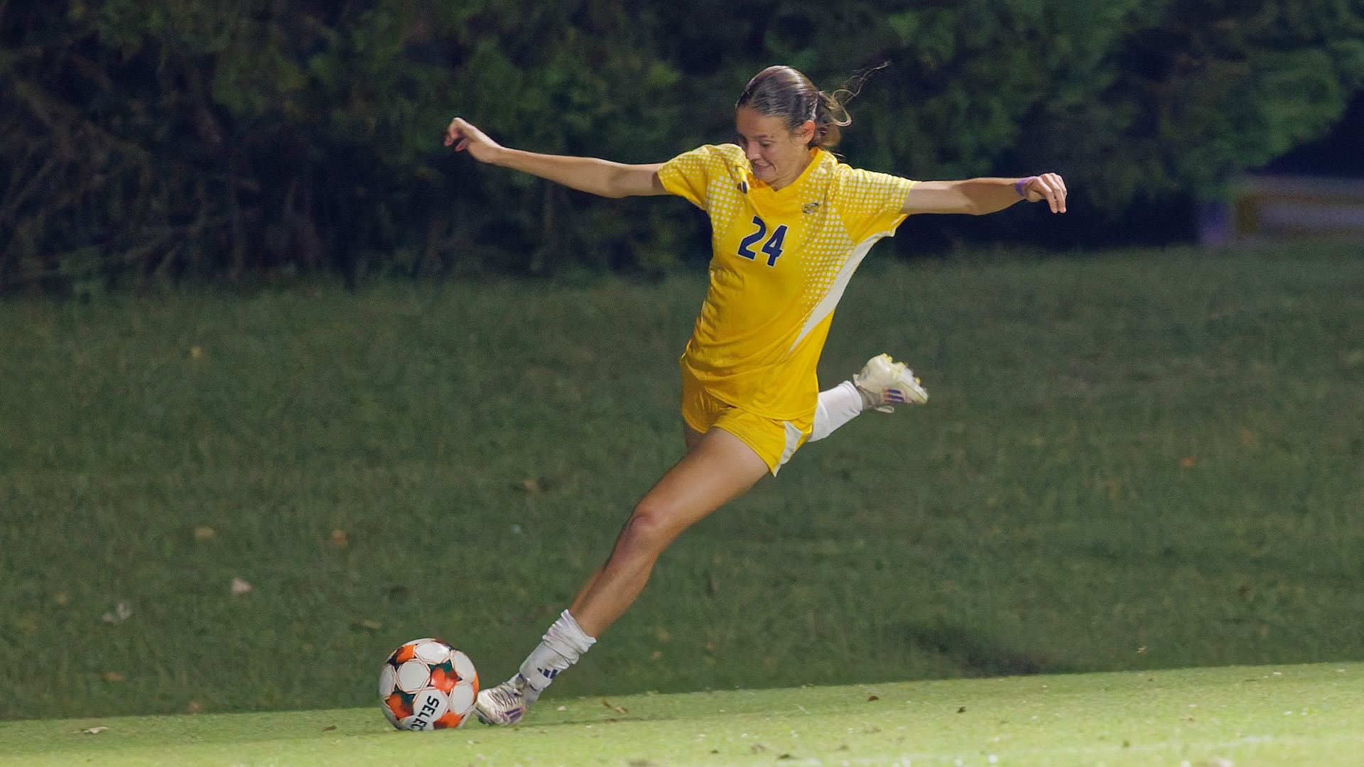 Zoie St John with arms out coming up on ball for big kick