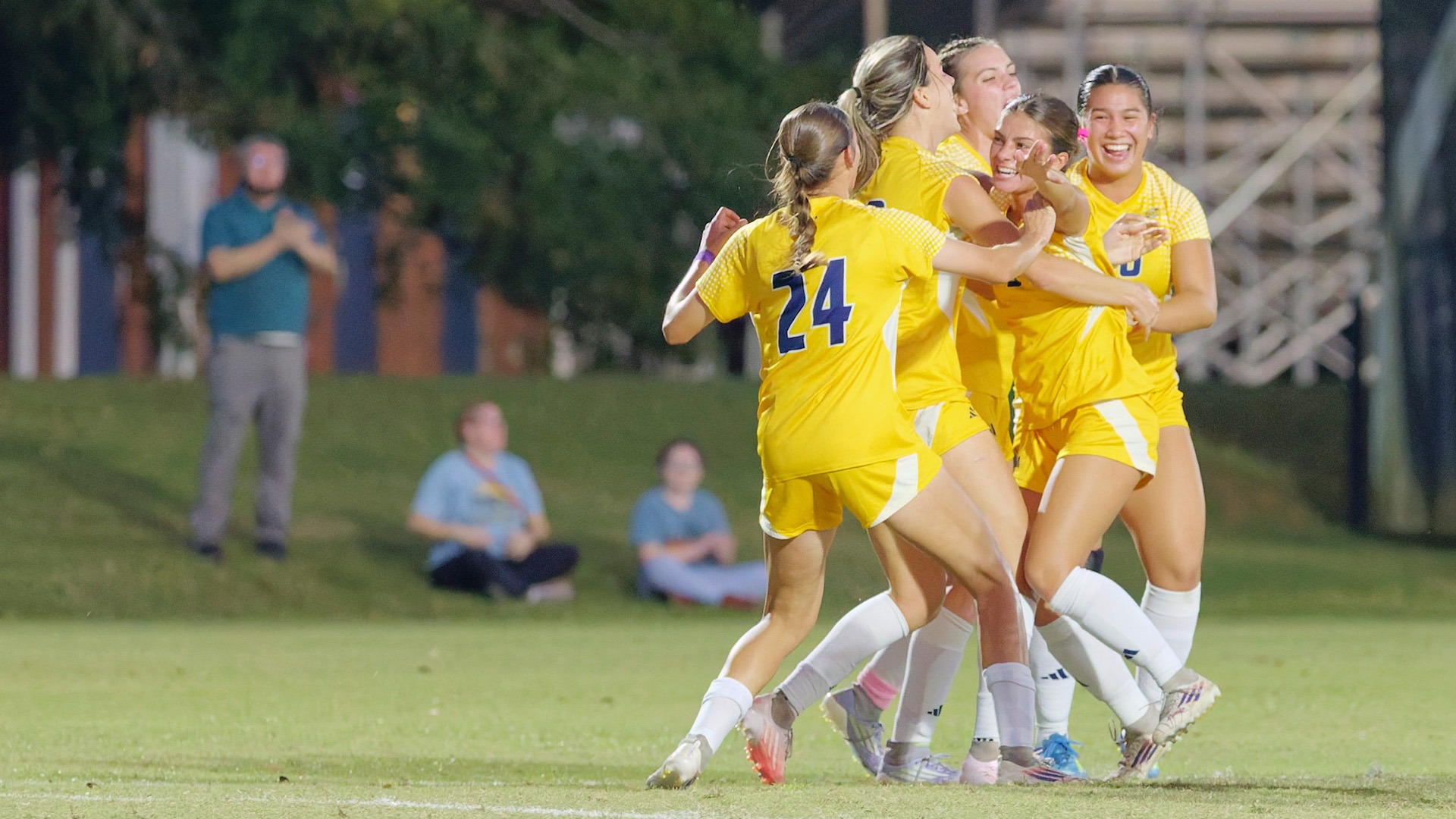 Ladies celebrate with group hug following goal vs Lander