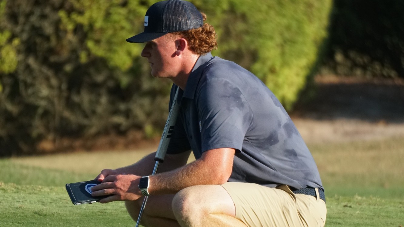 Jones at Hurricane Invitational squatting on green