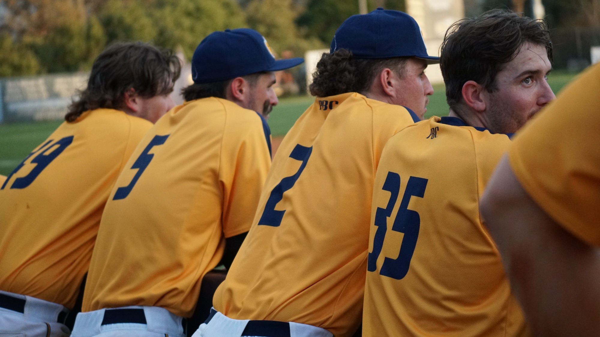 Baseball players outside dugout vs Tampa