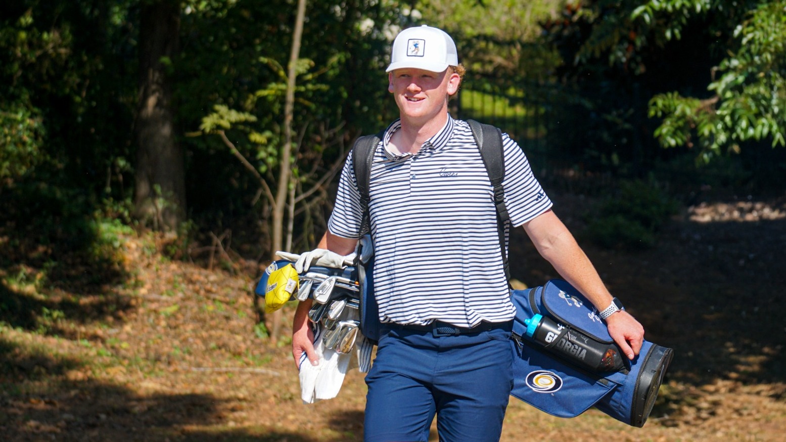 Jones walking with golf bag