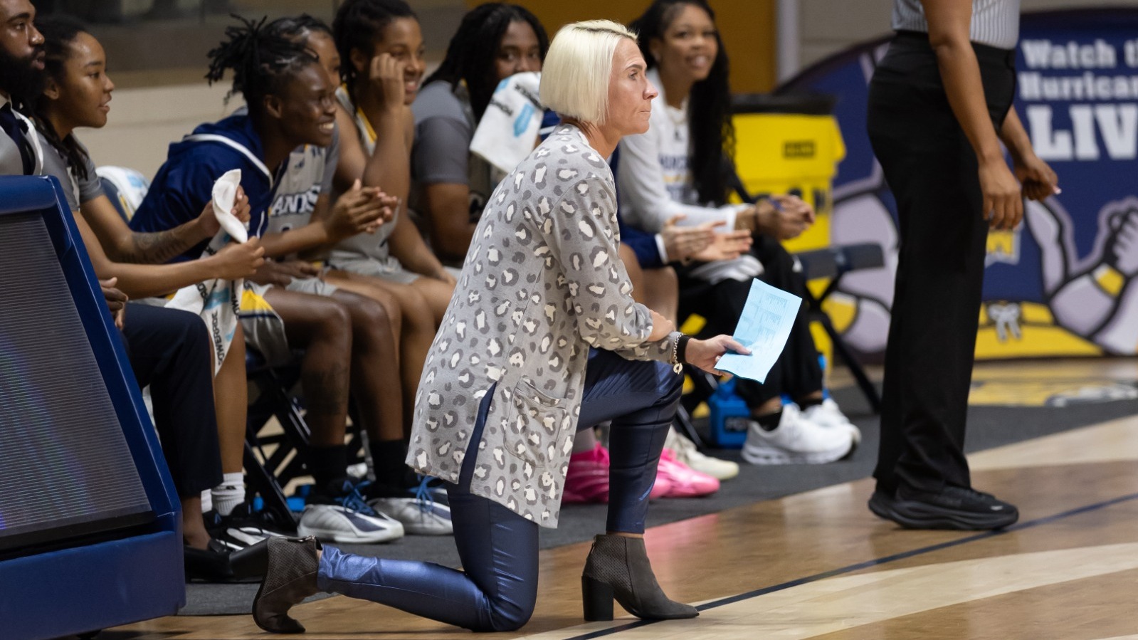 Missy Tiber on knee watching Lander game