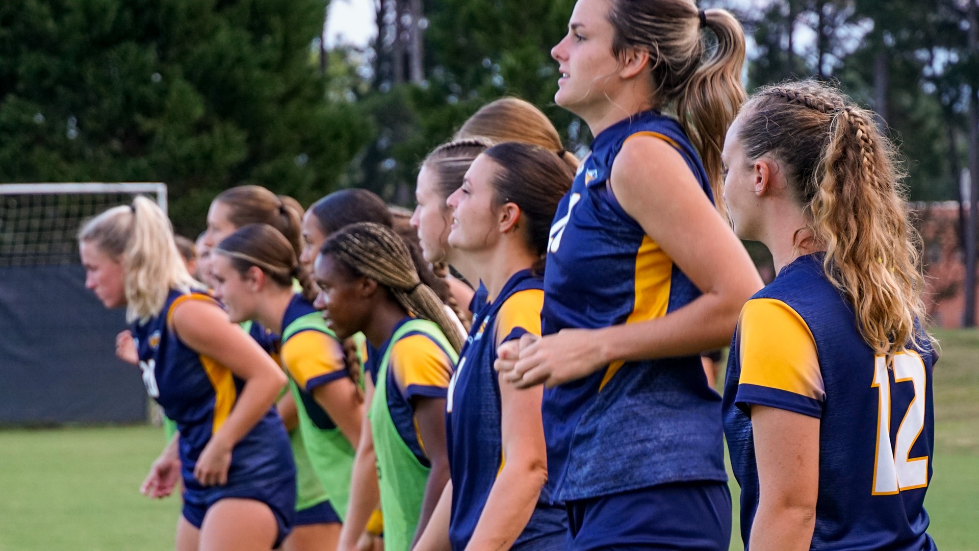 Line of womens soccer players prior to kickoff on senior night