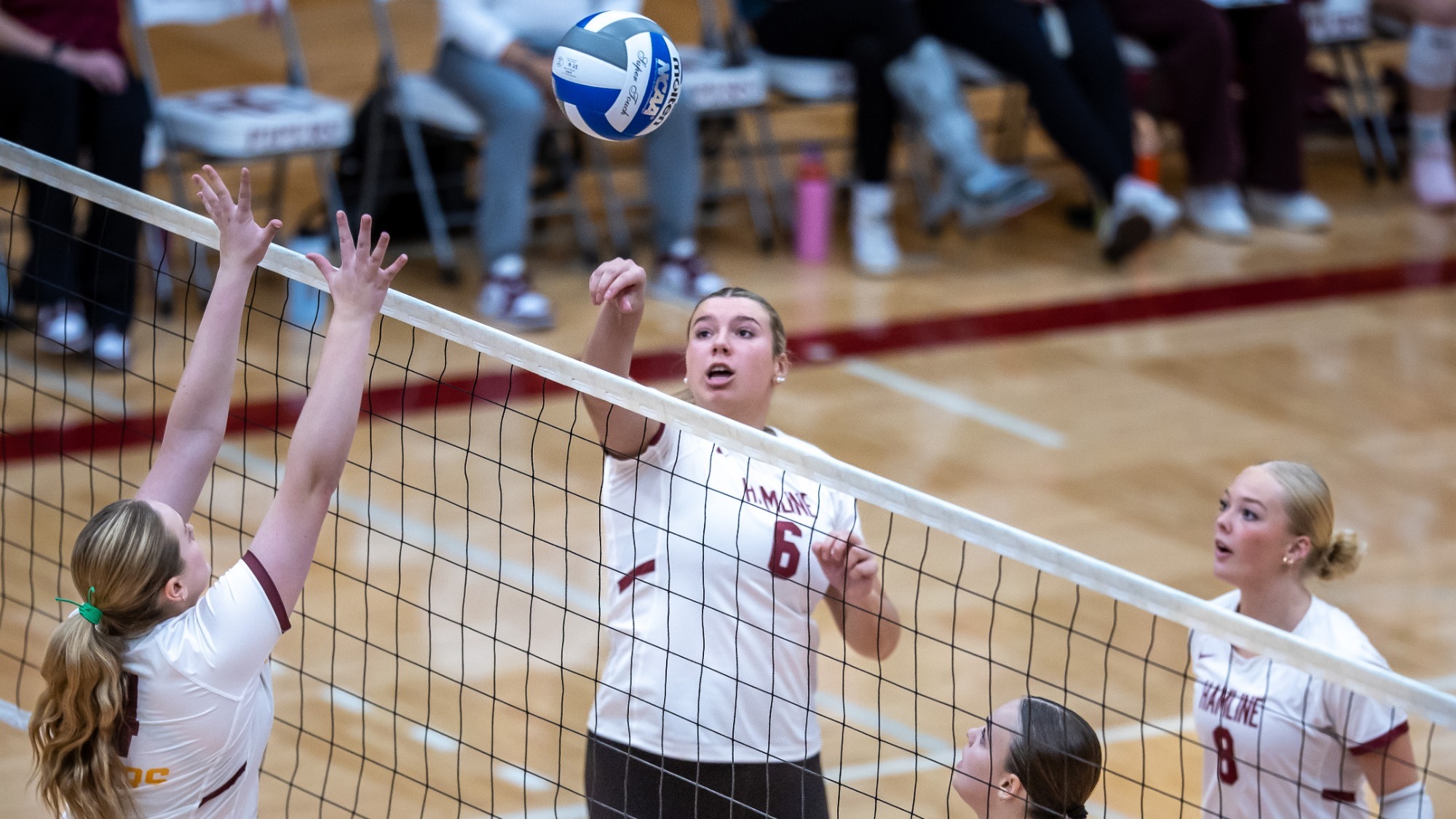 Nora Cairns hitting the ball over the net