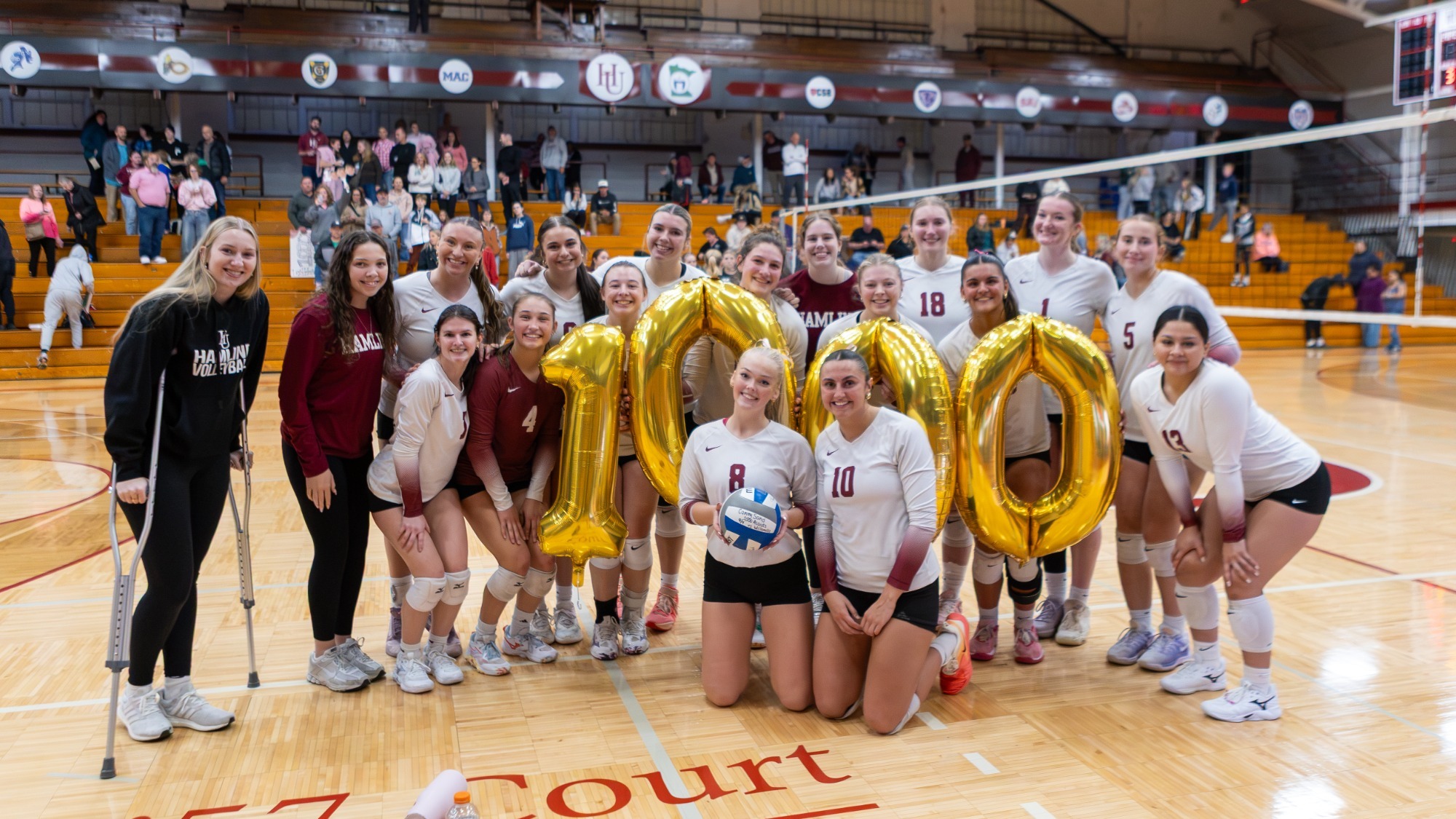 Volleyball team celebrating Lexi Helmin 1000 kill and Cameryn Sand 1000 assist milestones