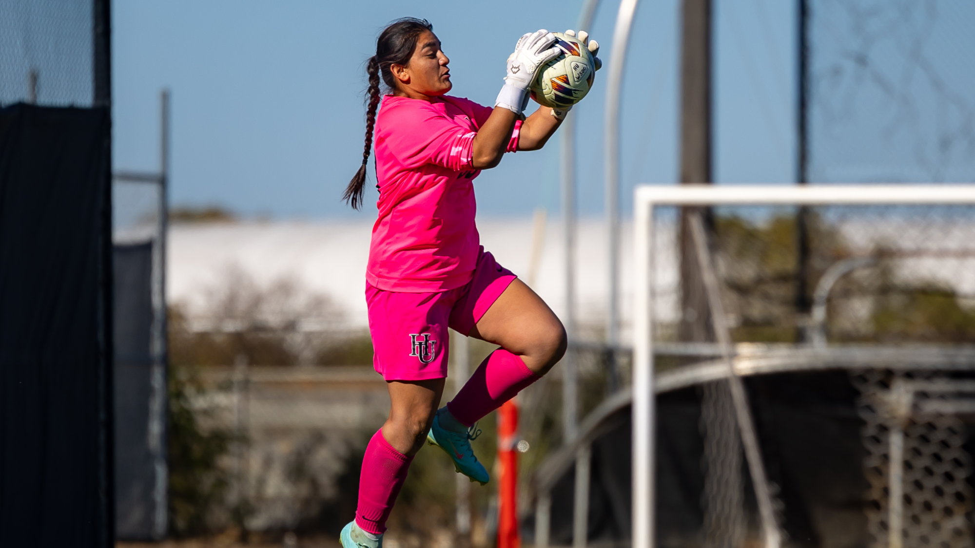 Sharis Garcia jumping for a save against Bethel