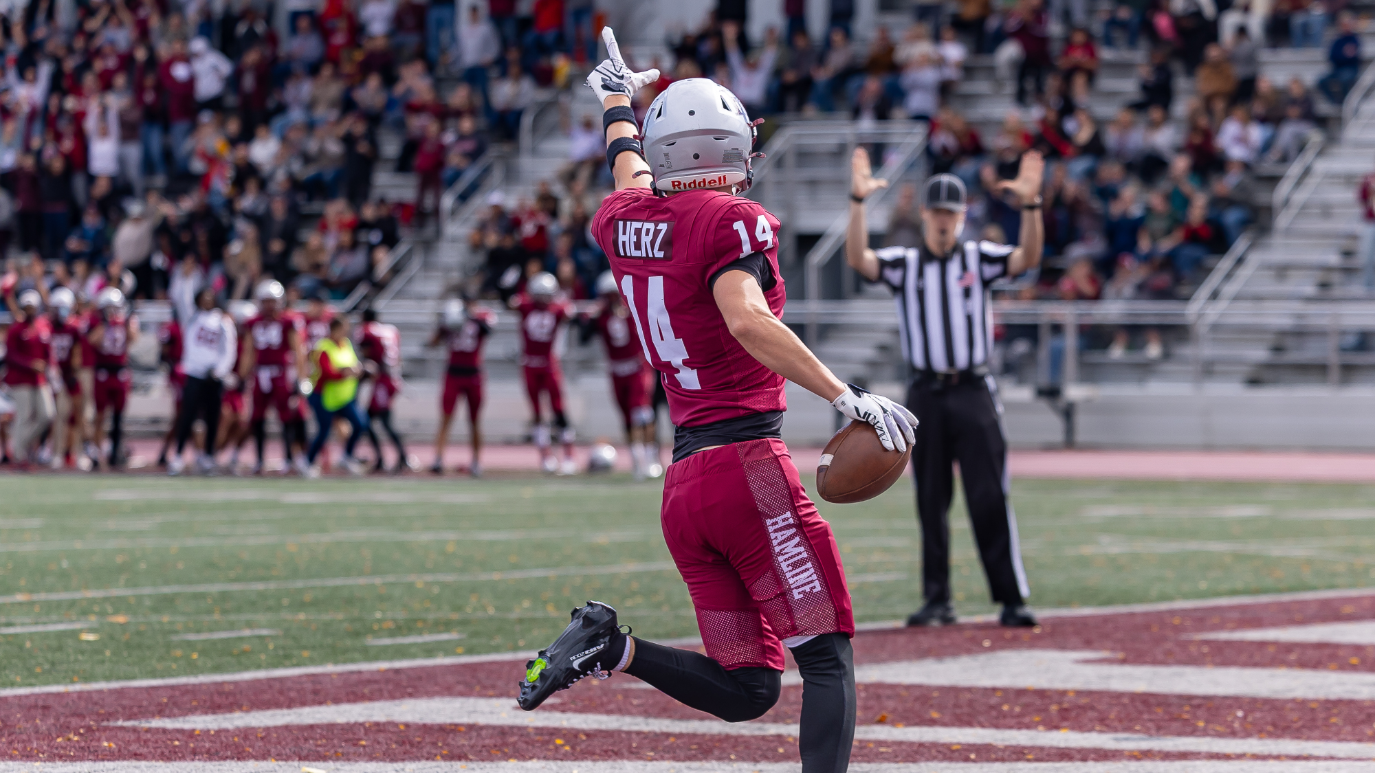Aiden Herz celebrating a touchdown against Macalester