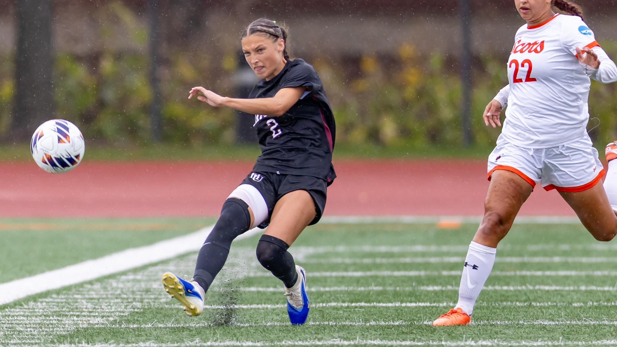 Athena Lopez kicking the ball against Macalester