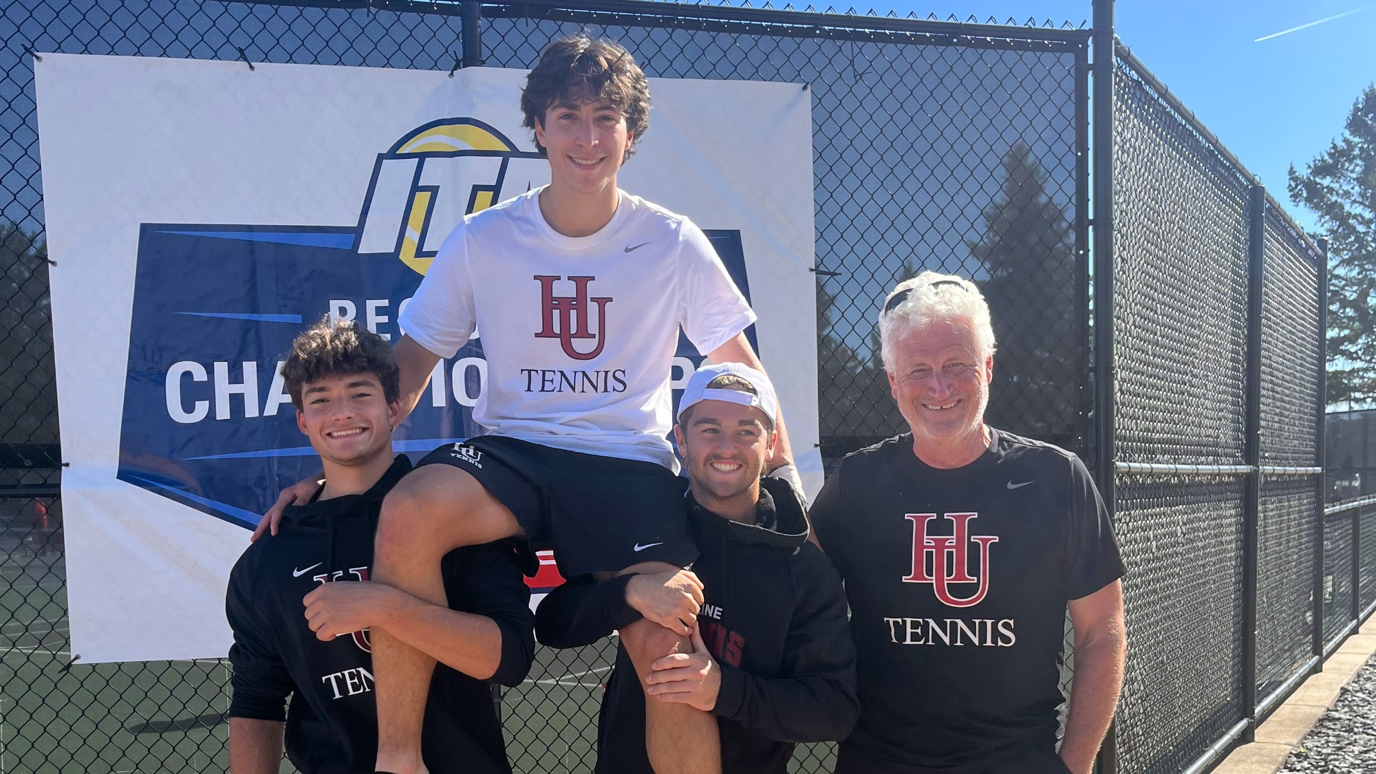 Turman Vogel held up by teammates after ITA B Singles Victory