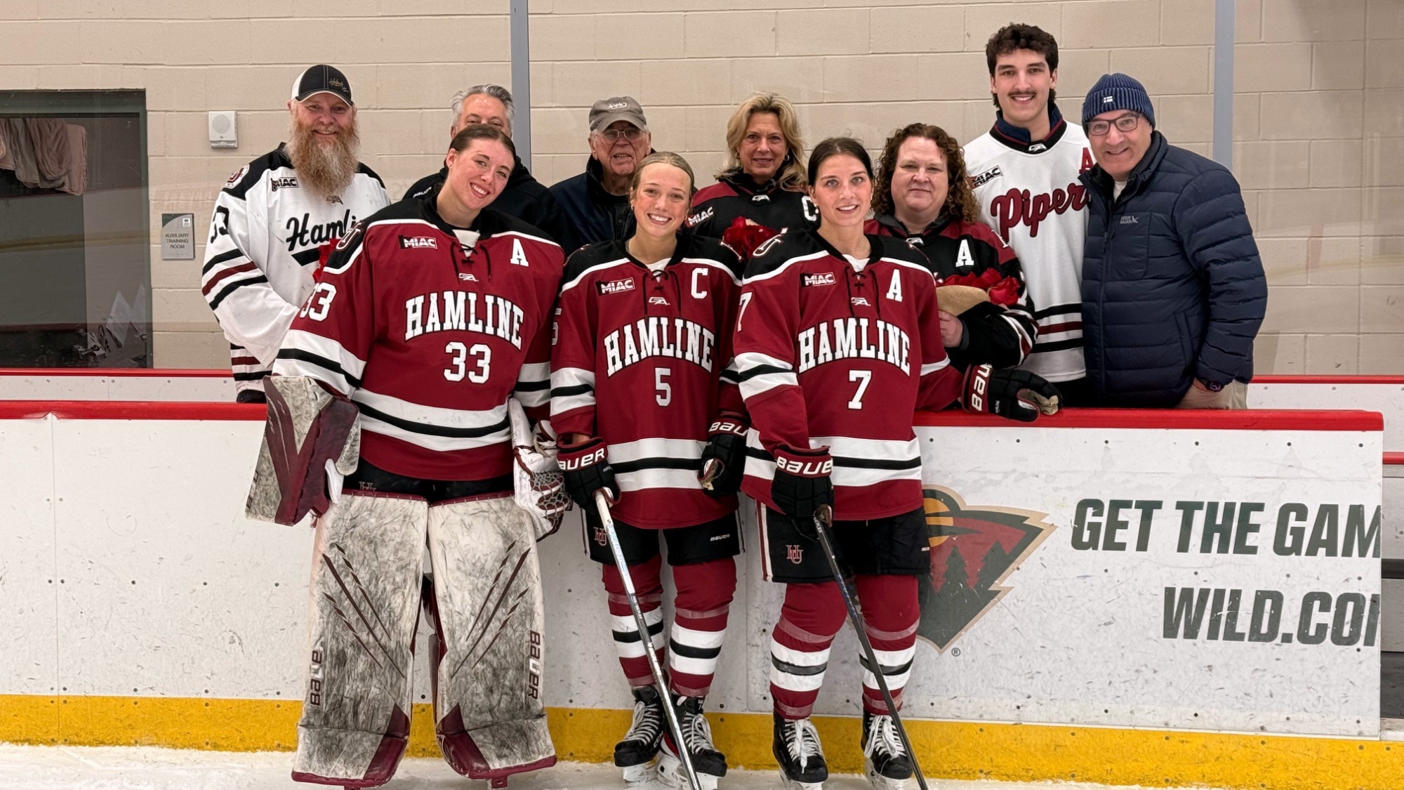 Ryskamp, Lindgren, and Nordick with families on Senior Day