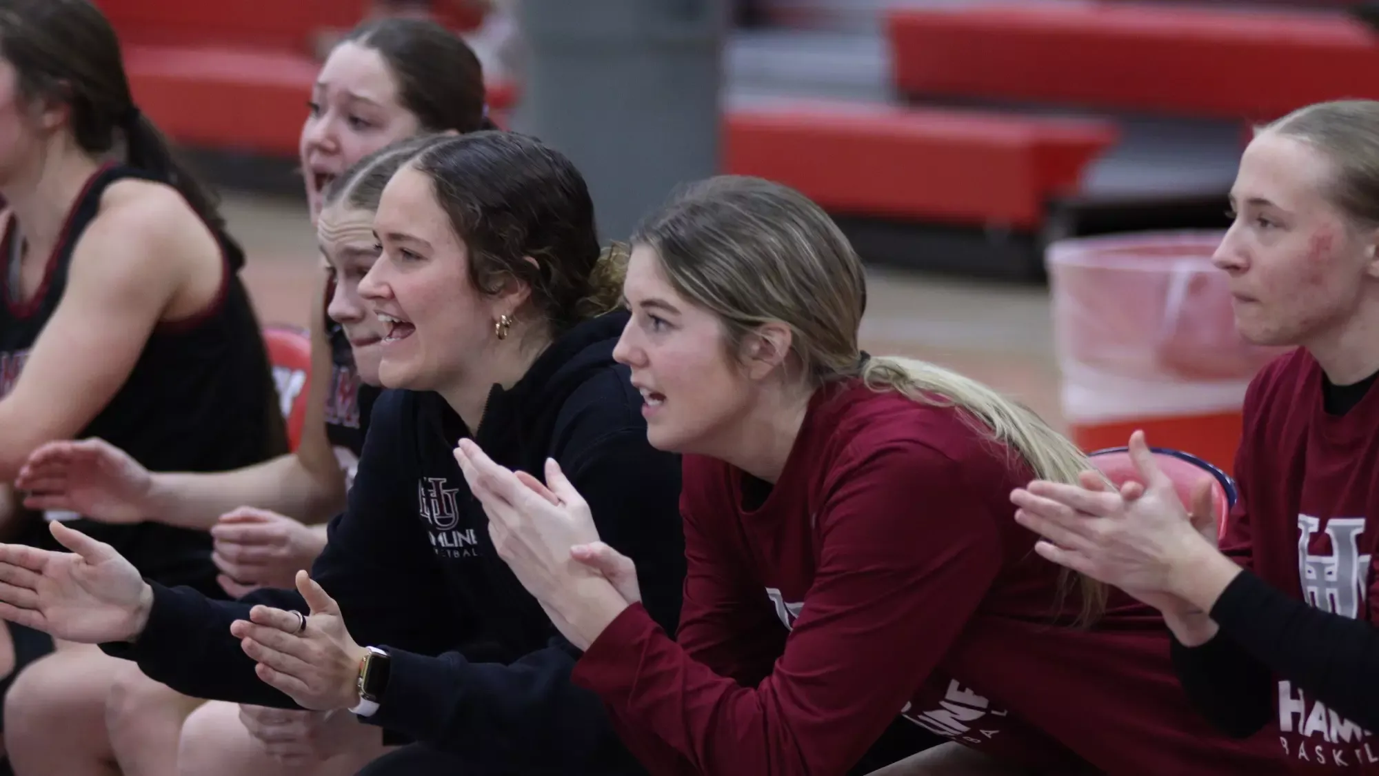 Hamline Women's Basketball bench cheering in MIAC Quarterfinal vs SMU
