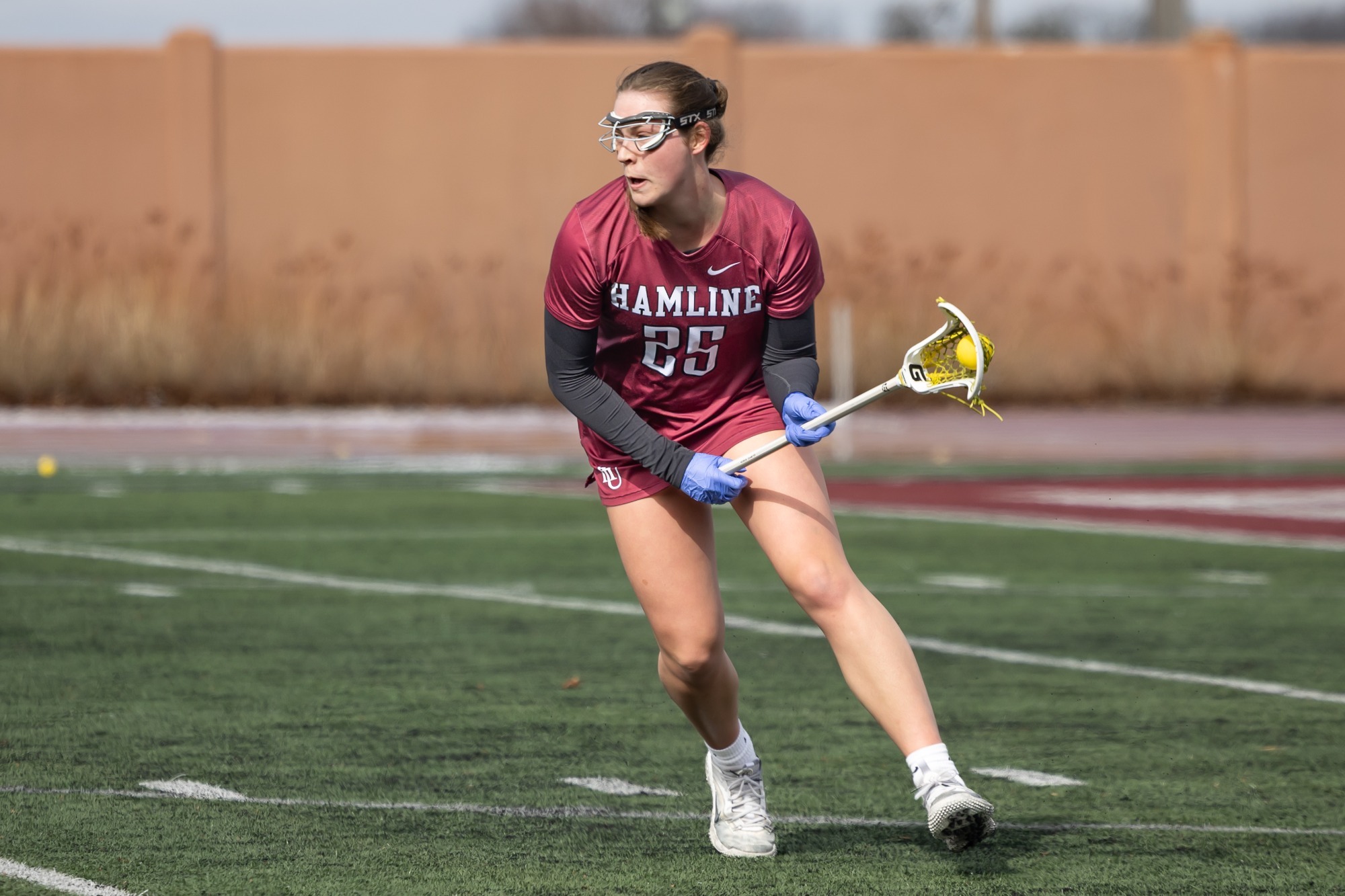 Lauren Moorhouse looks to run with ball against Augustana