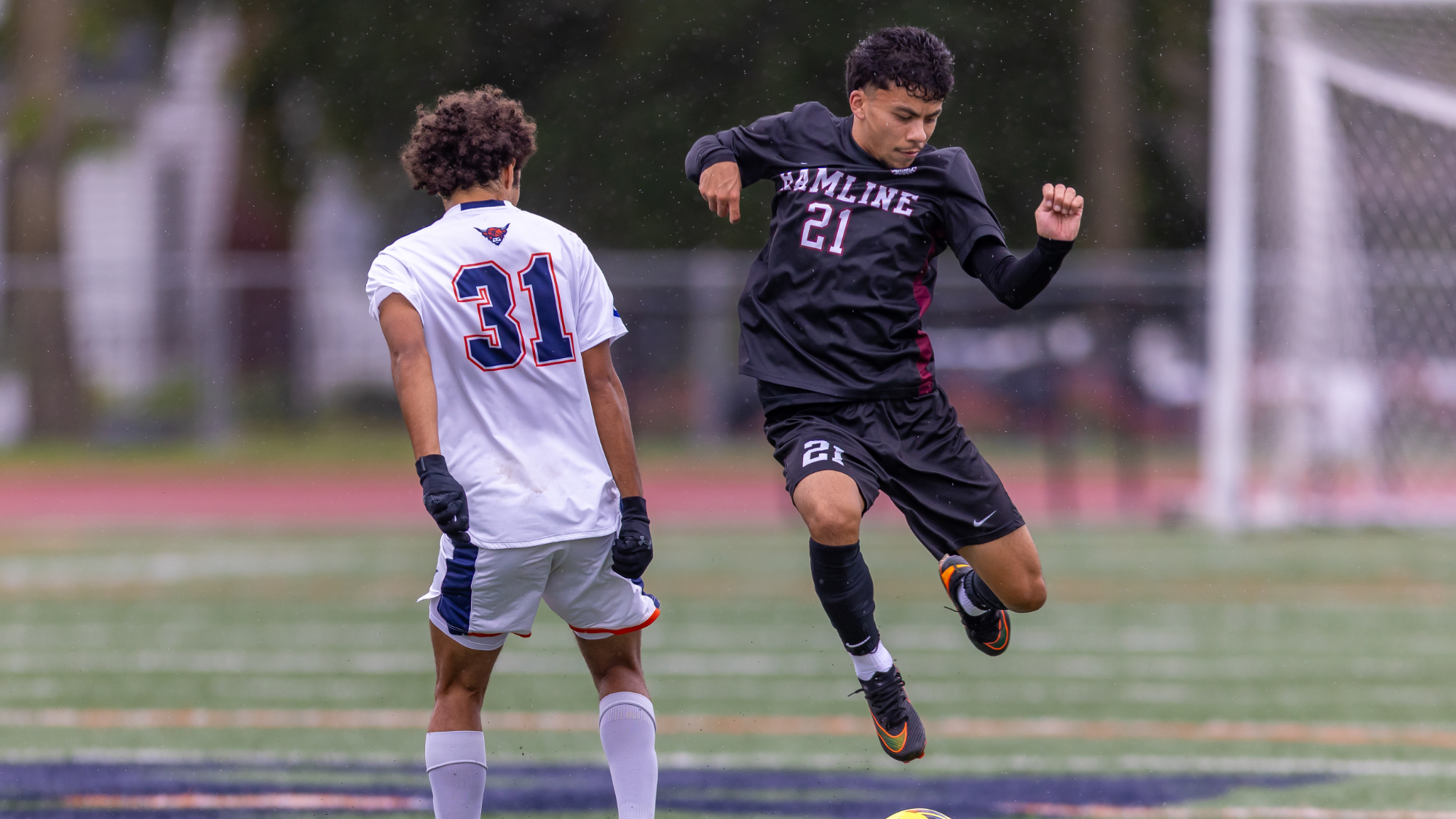 Anthony Porter jumping for a header against Macalester
