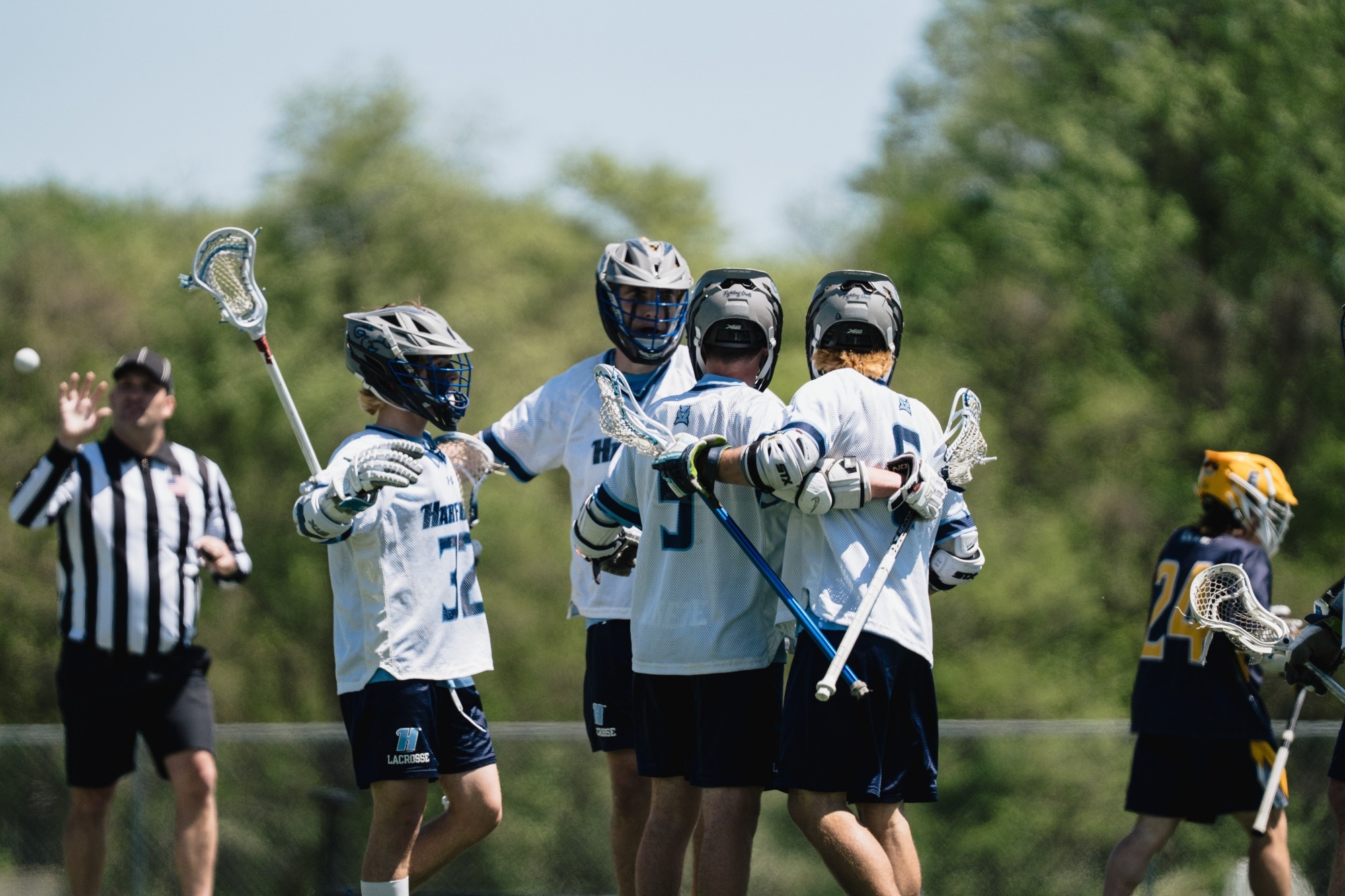 Multiple Harford Men's Lacrosse players celebrate a goal