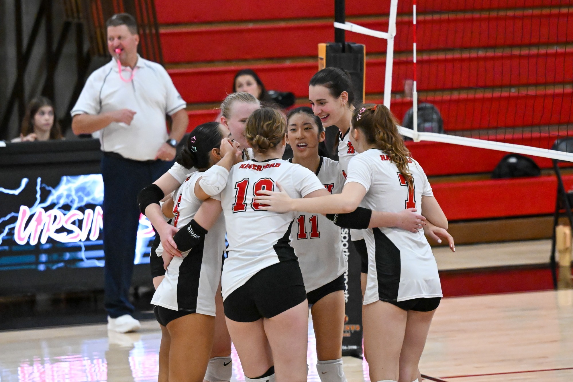 Volleyball huddle versus Ursinus 