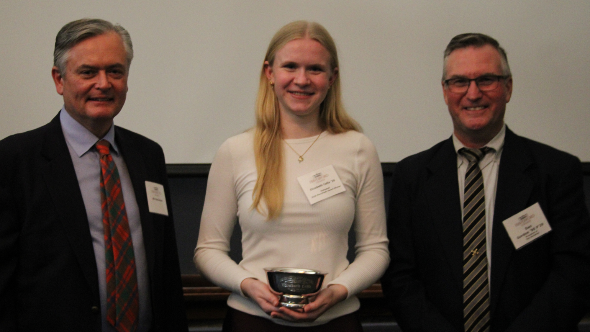 Elizabeth Cella is awarded the Macintosh Award, joined by Dan Gordon '90 and Bill Macintosh, grandson of Archibald Macintosh