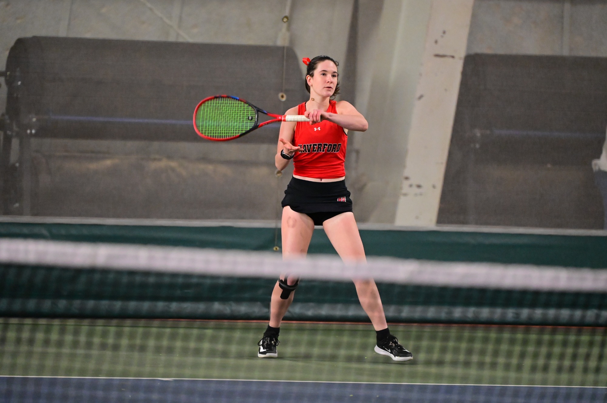 Addy Kreutel returns serve during an indoor match at Haverford's Alumni Field House