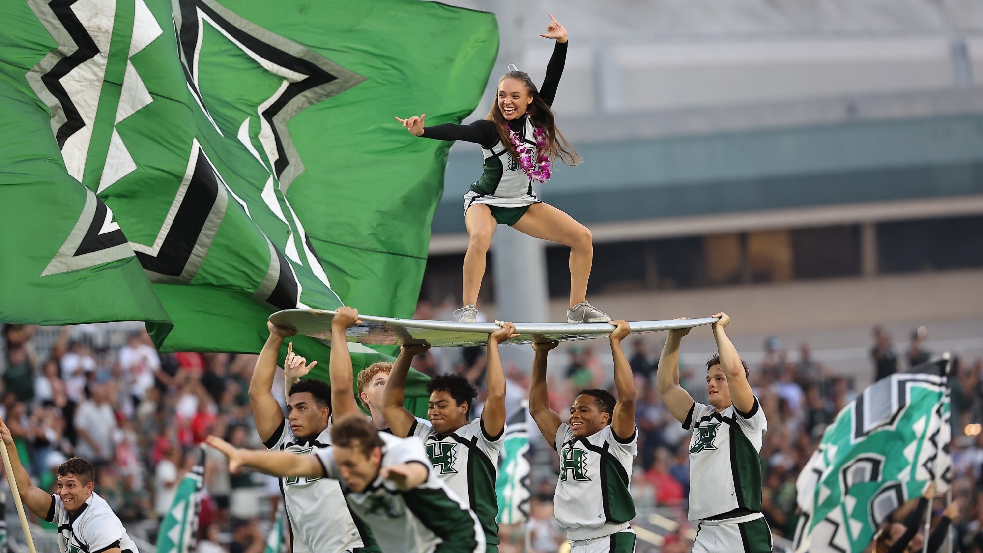 Cheerleader on surfboard - UH football entrance