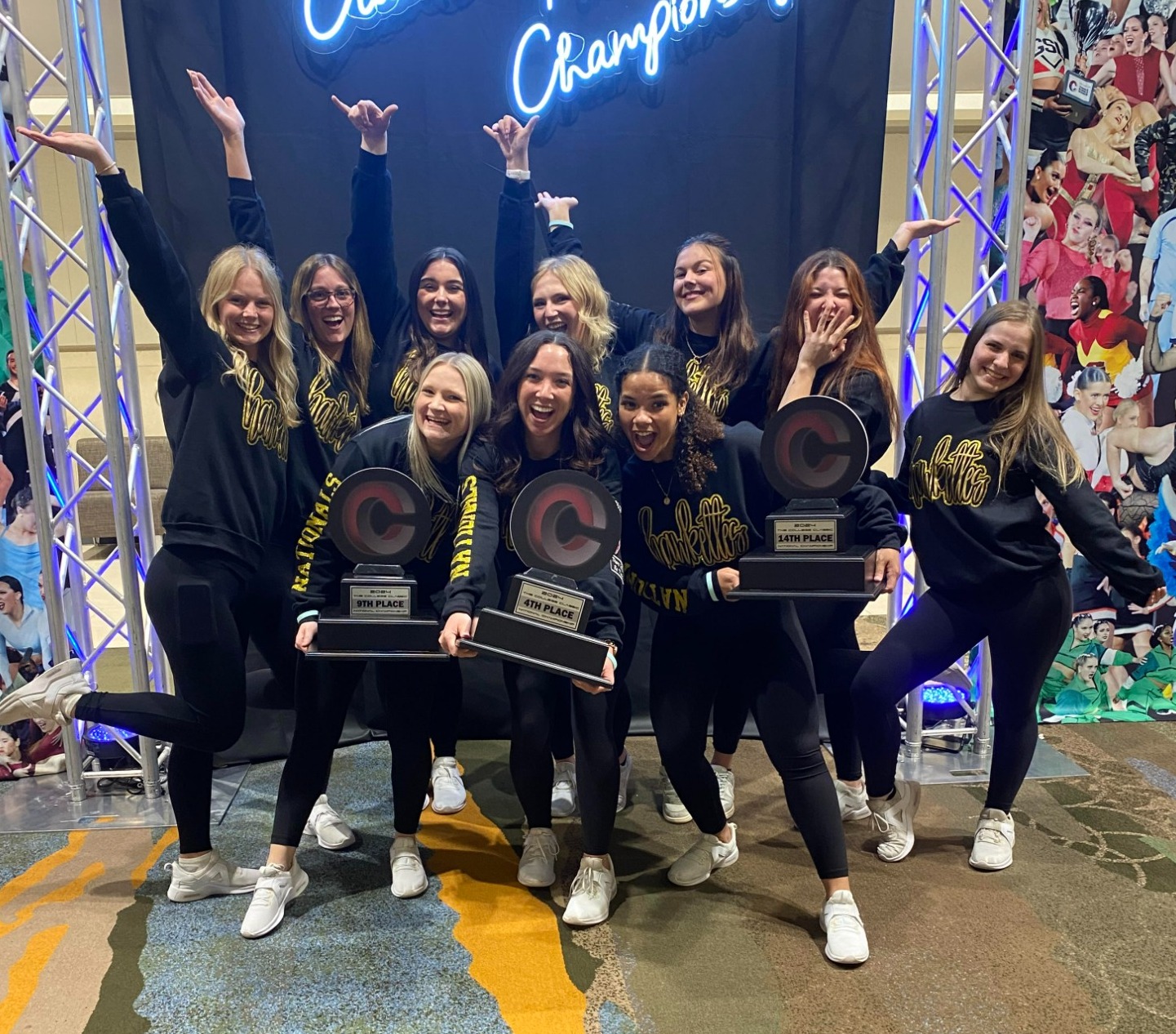 The Hawkettes pose with their three national titles