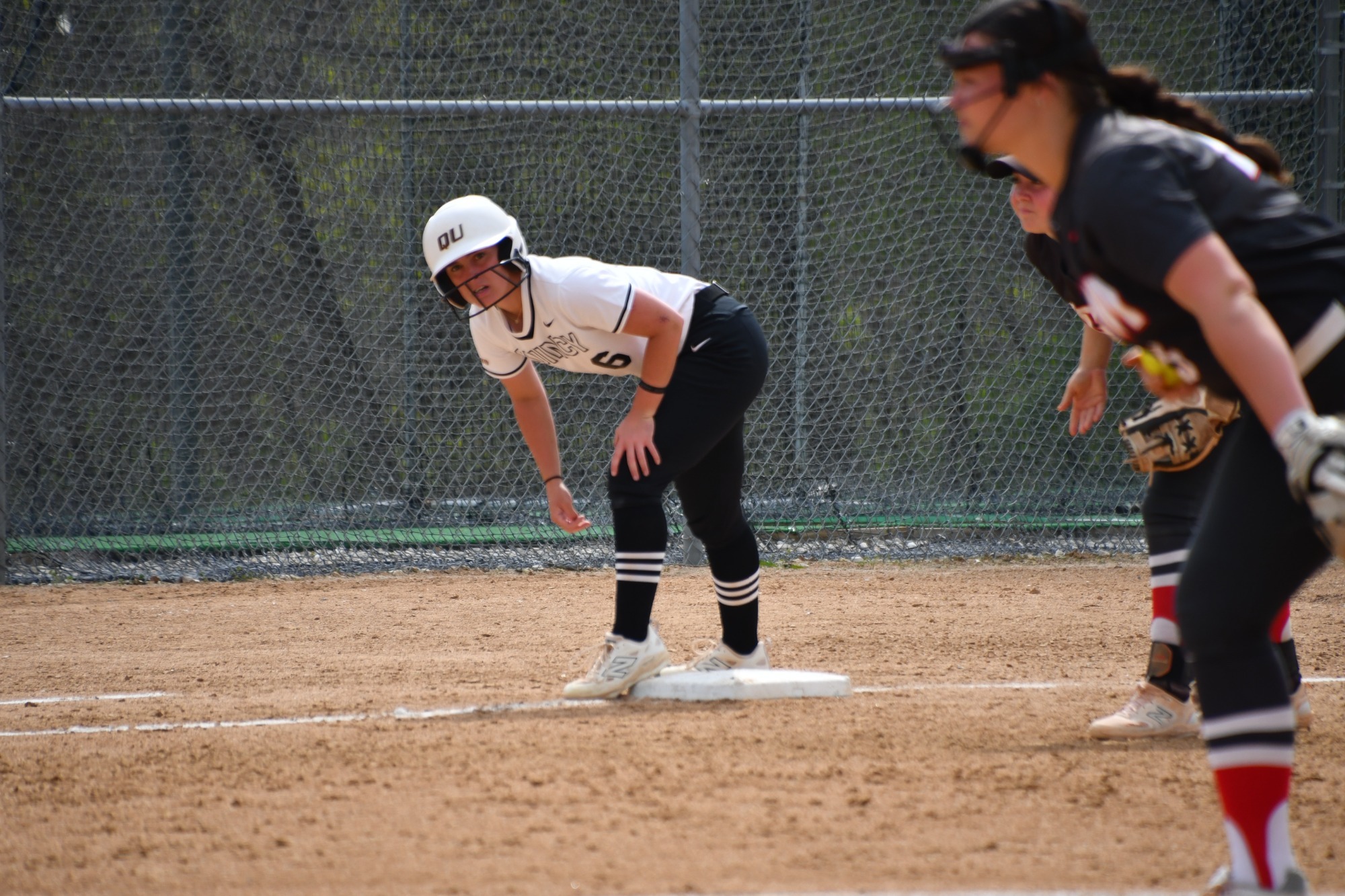Kenzie Moss stands on third base.