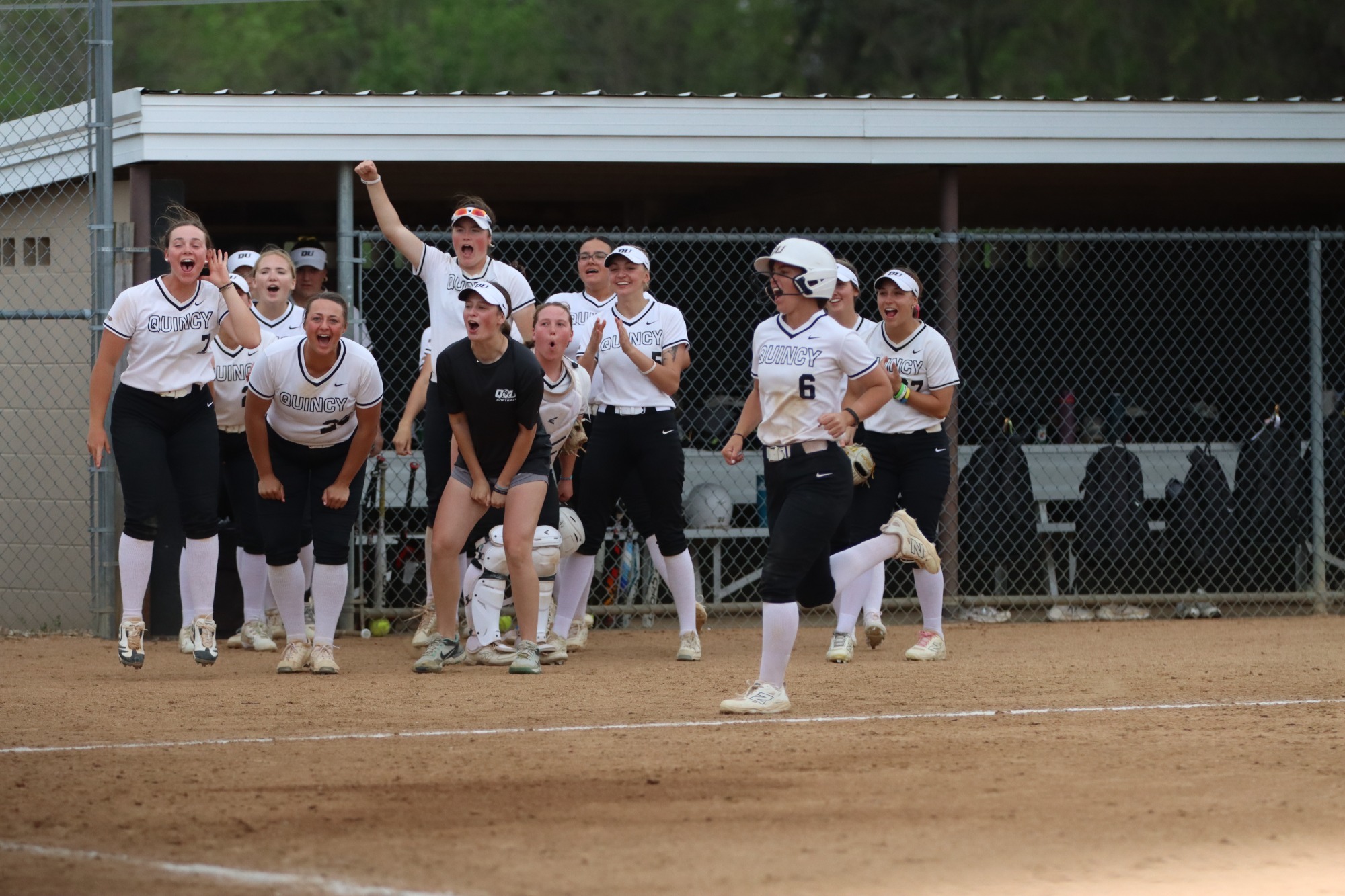 Hawks celebrate the game winning run in extra innings as Moss makes her way to home. 
