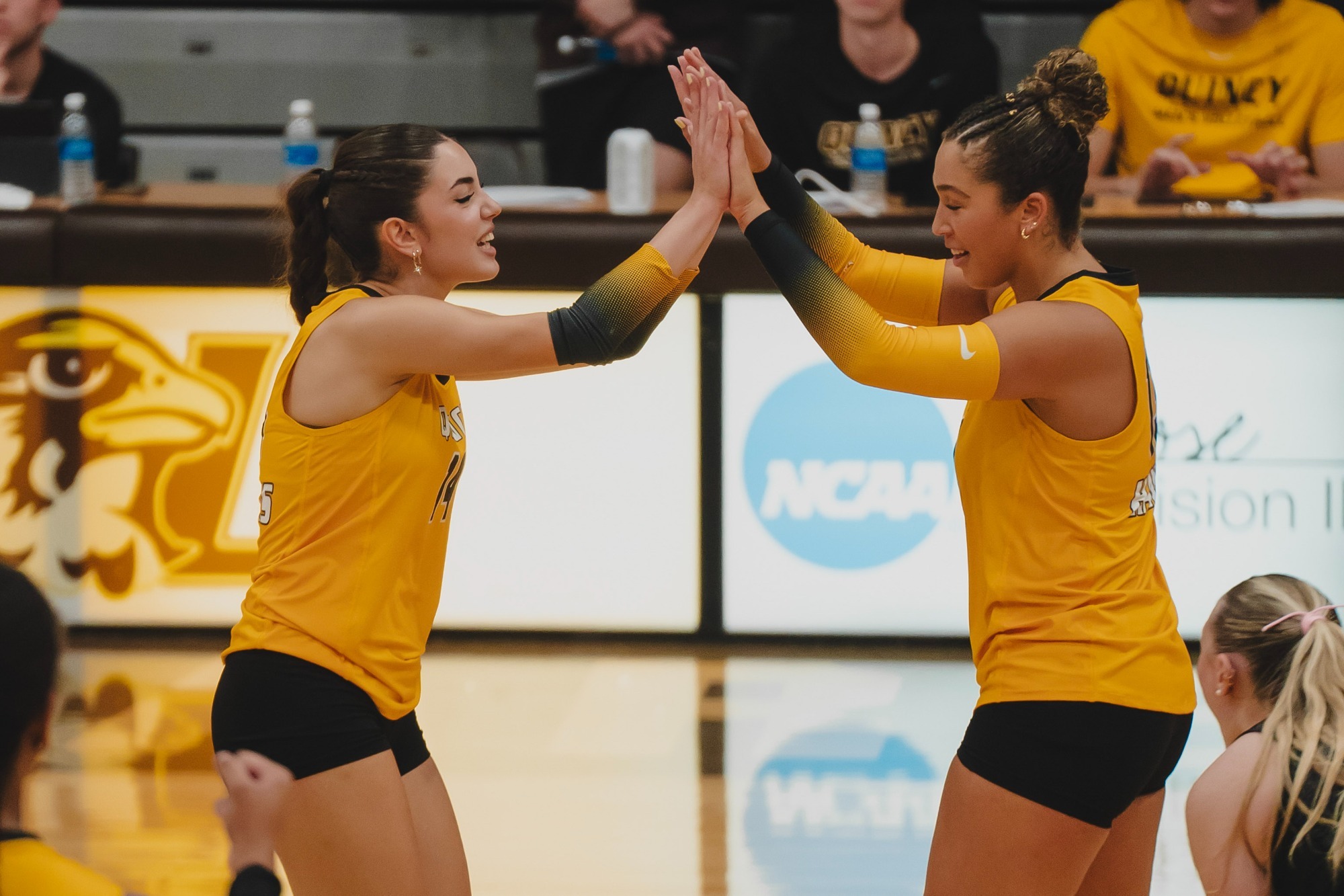 Aysem Kocaalp (left) and Macey Rocco (right) exchange high-fives.
