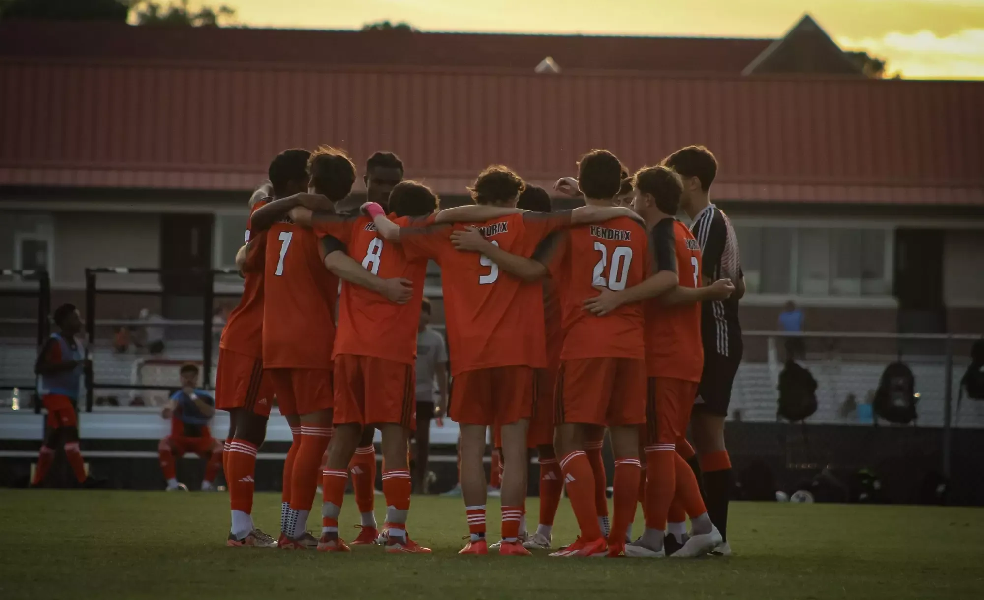 men's soccer group huddle