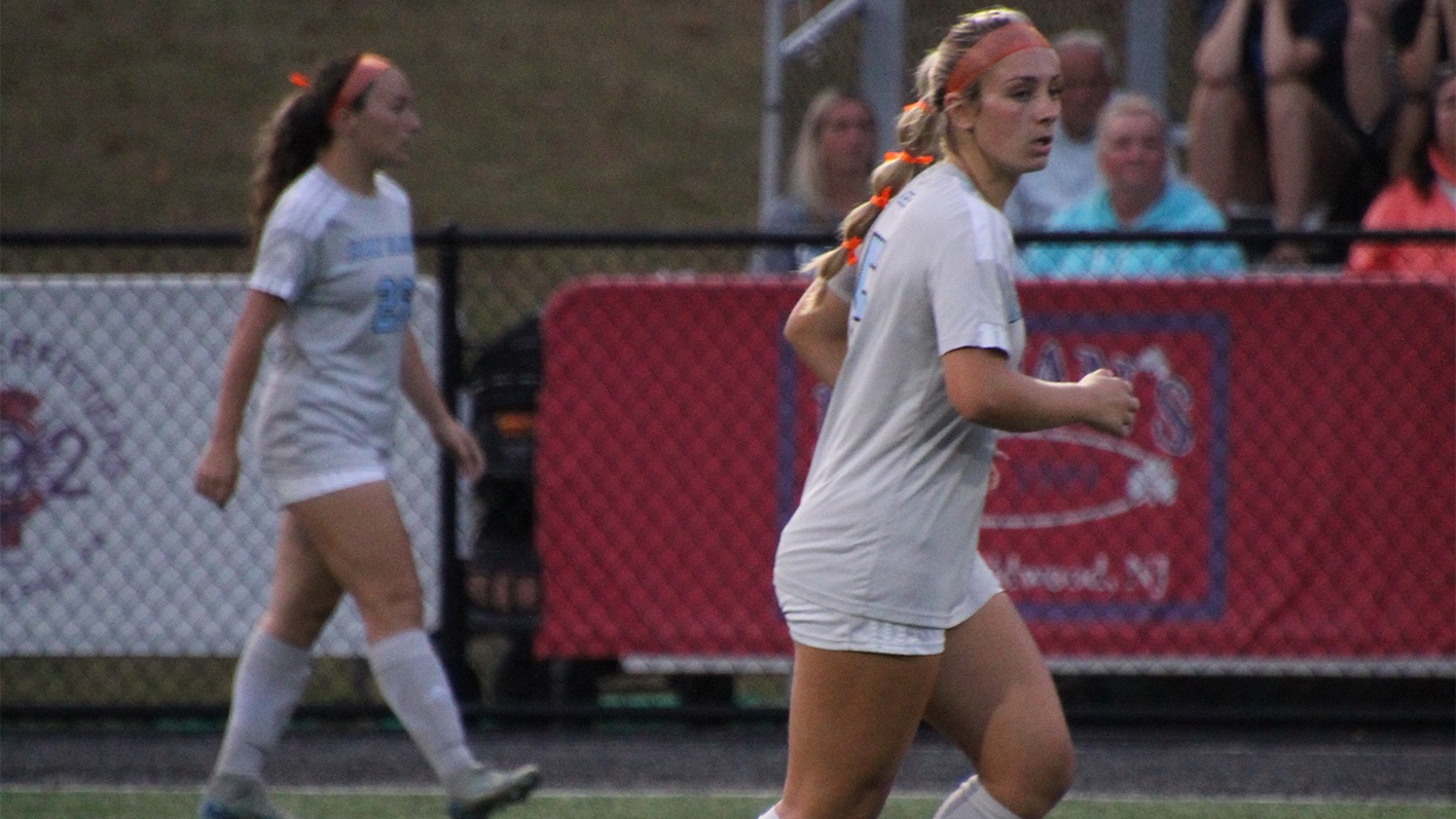 A closeup of Allison Devine from the right side, as she looks to her right