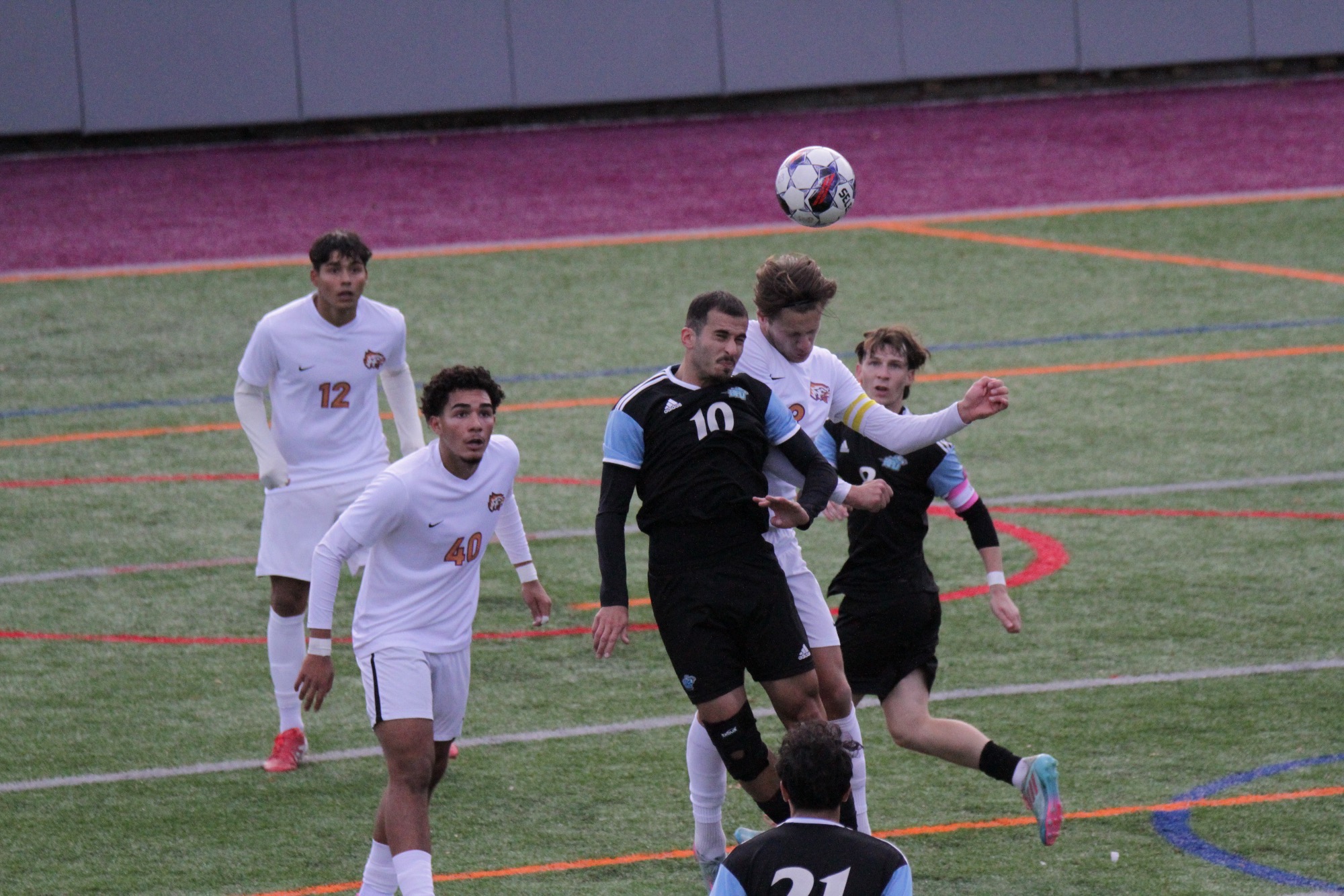 Dimitri Lekishvili and an opponent jumping in the air to head the ball