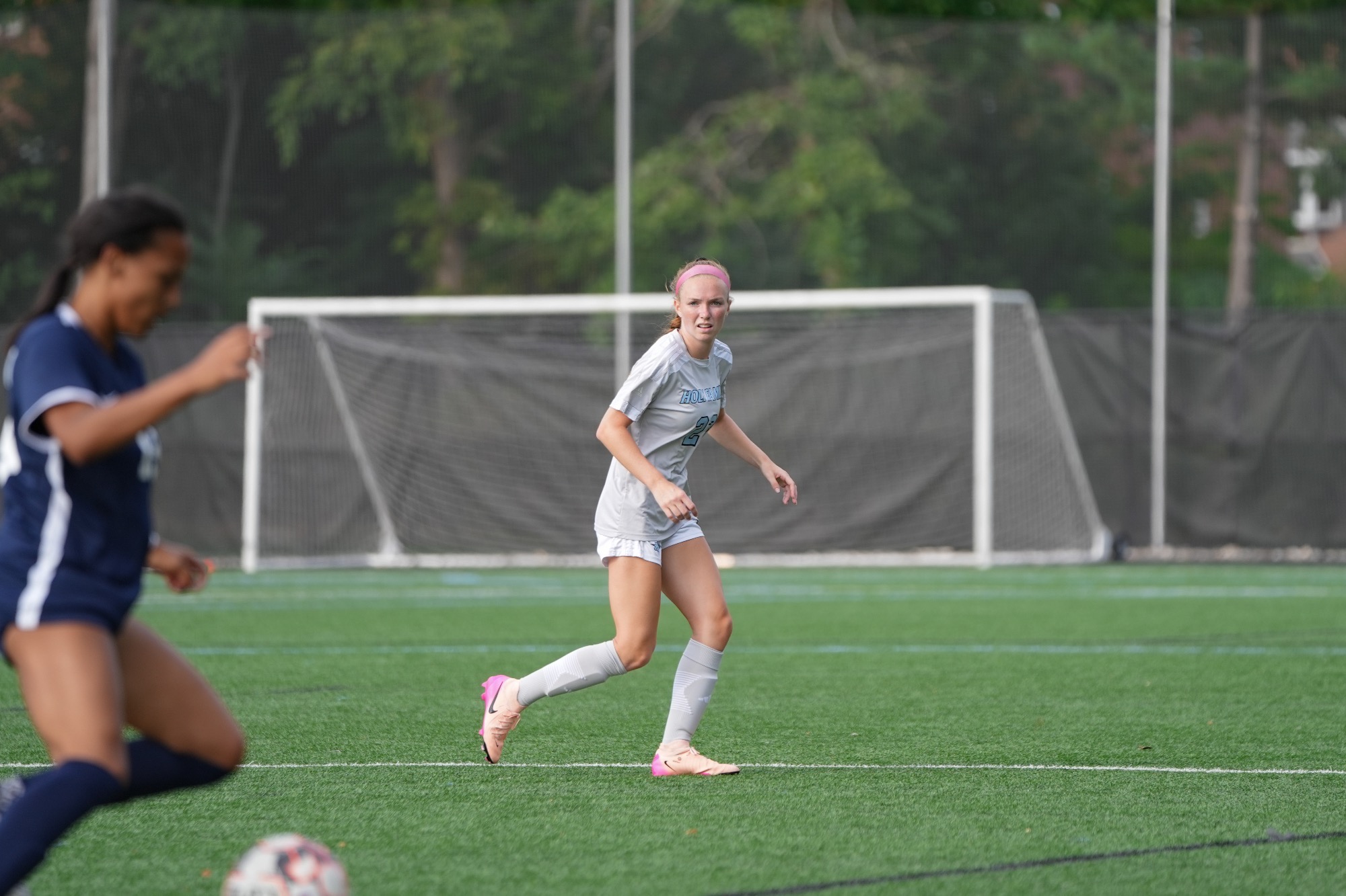 Julia Leibig looks on as an opponent dribbles the ball