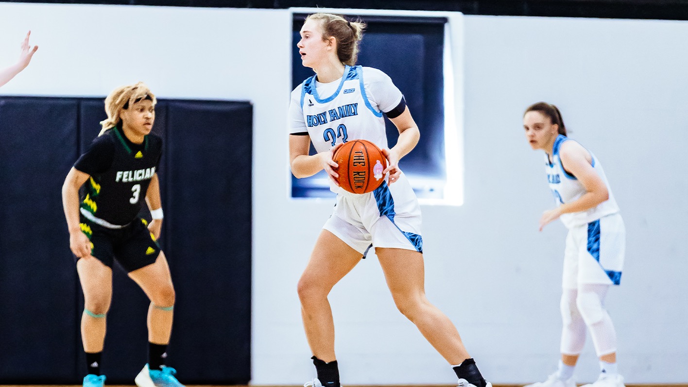 Lauren Palangio standing in a triple threat position and holding the ball by her left hip, looking in front of her
