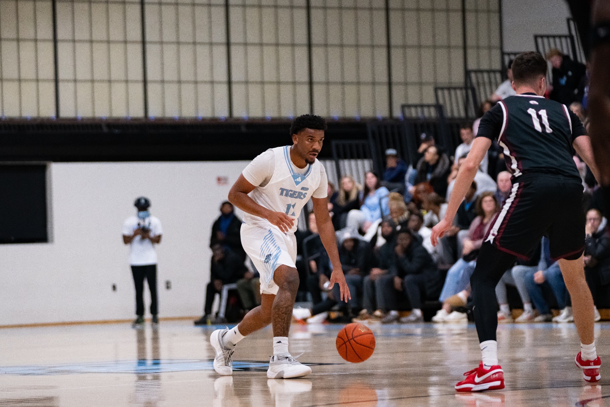 Omarion Jett looking focused, dribbling with his left hand in front of an opponent