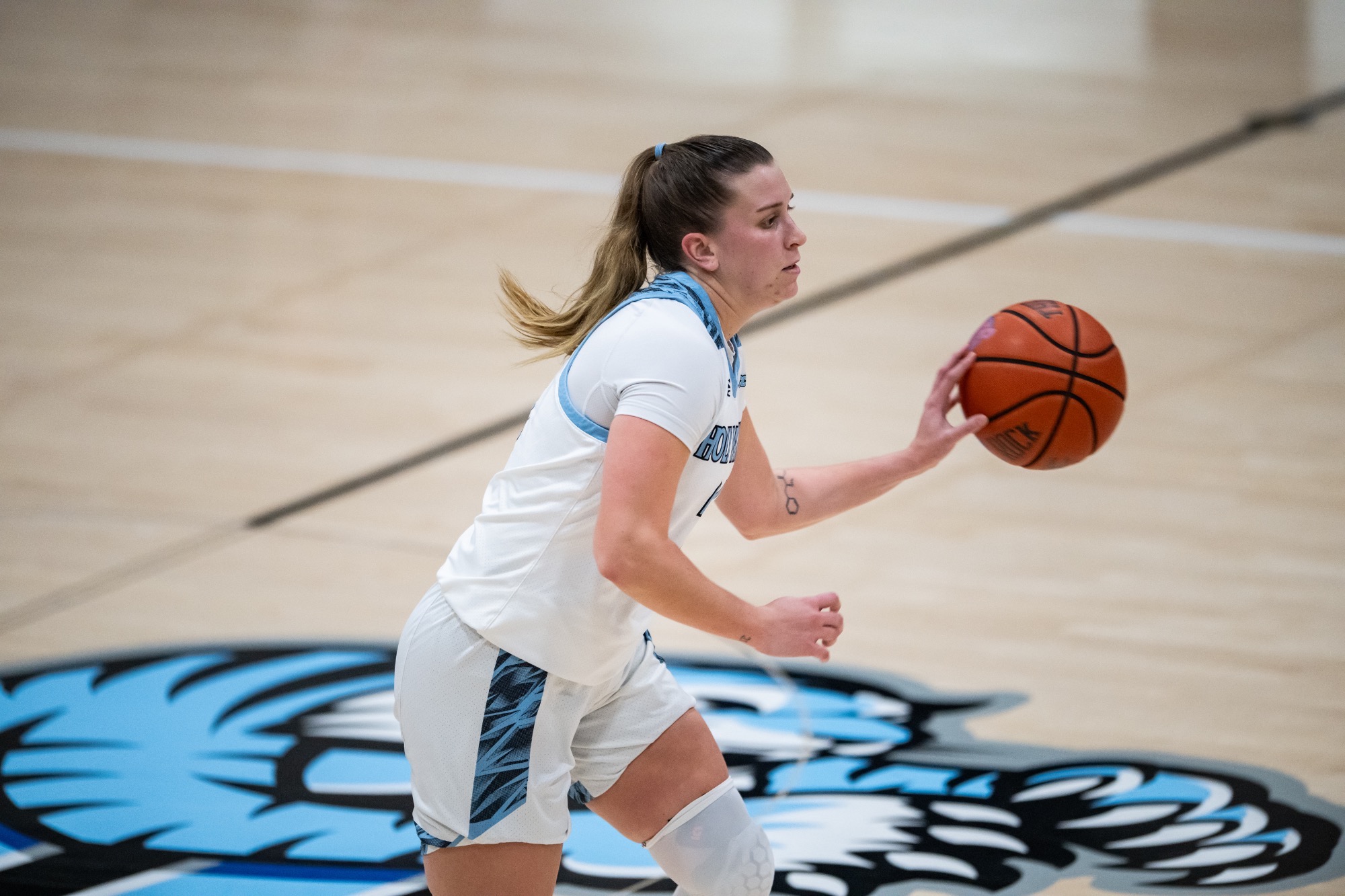 A closeup of Skyler Searfoss with the ball on the tip of her left hand