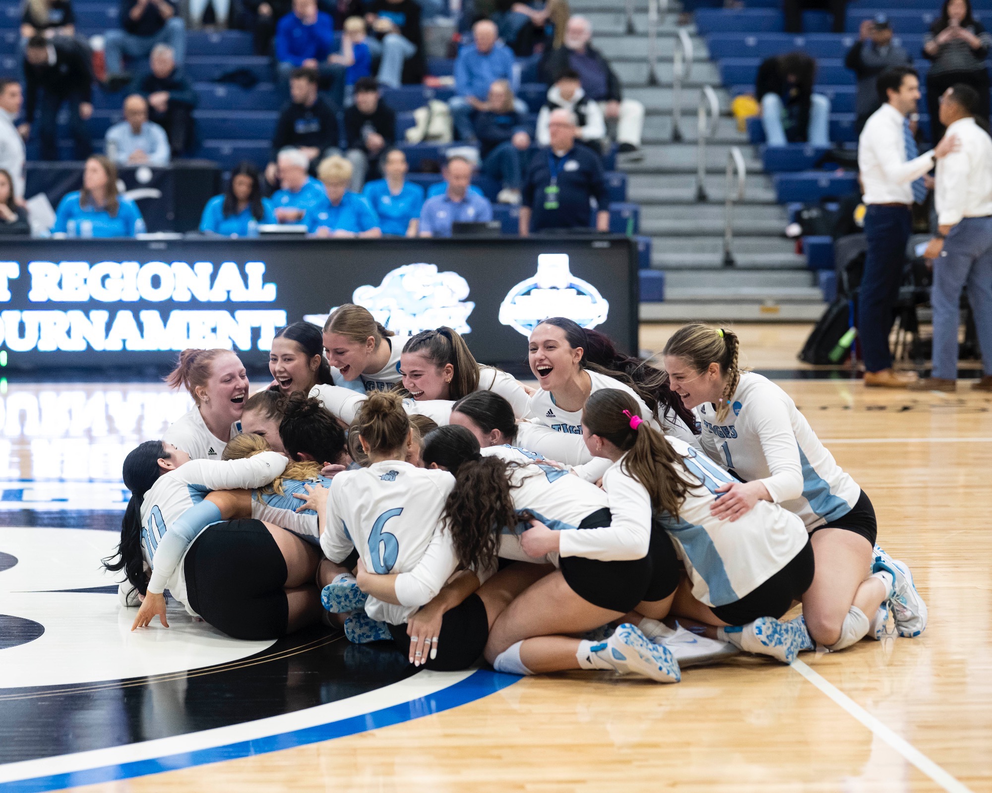 The HFU Volleyball Team dogpiles on the court after reversing sweeping Adelphi in the first round of the 2025 NCAA Tournament