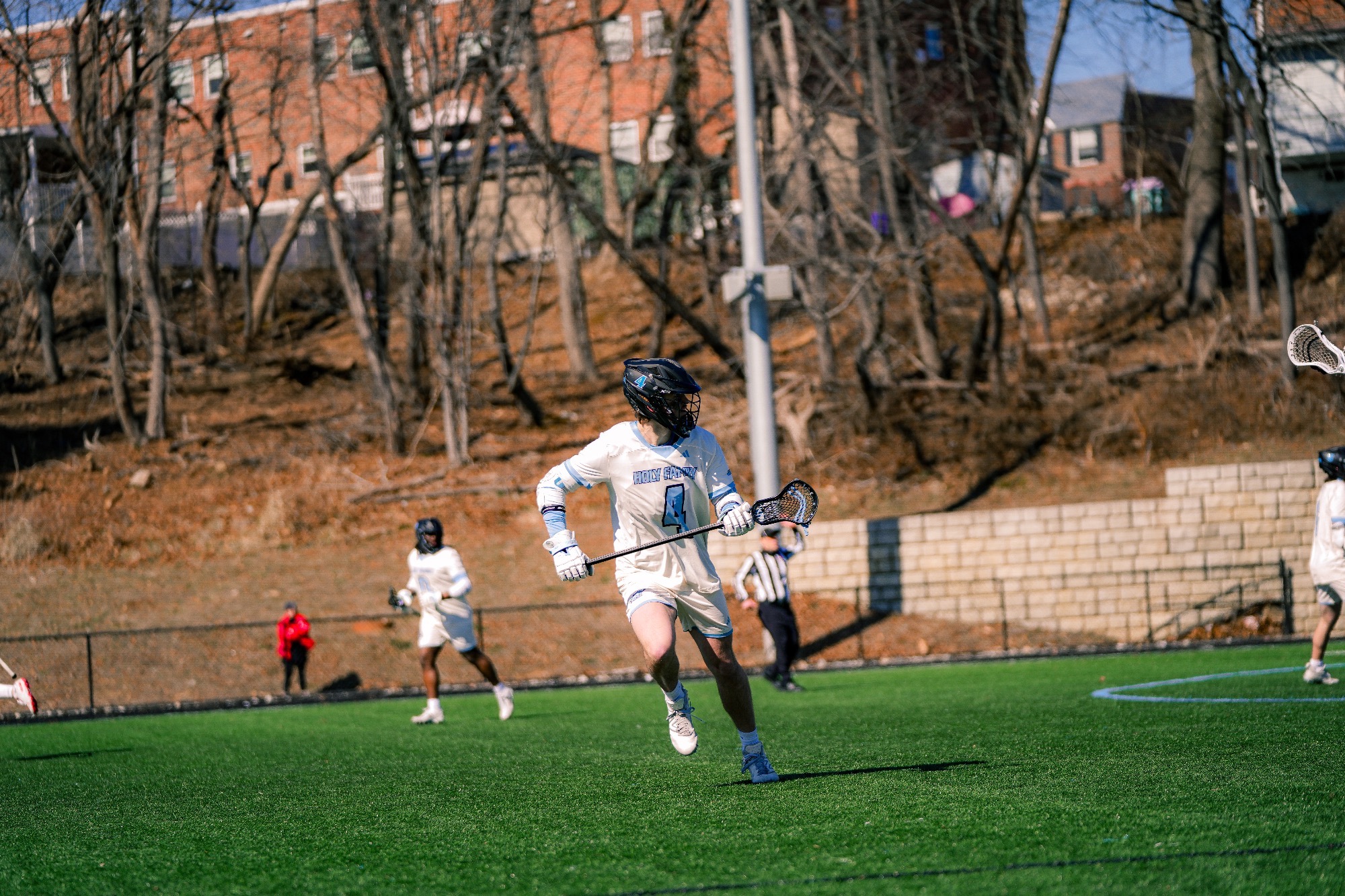 Jake Feeney looks to his left while running, stick in his hands