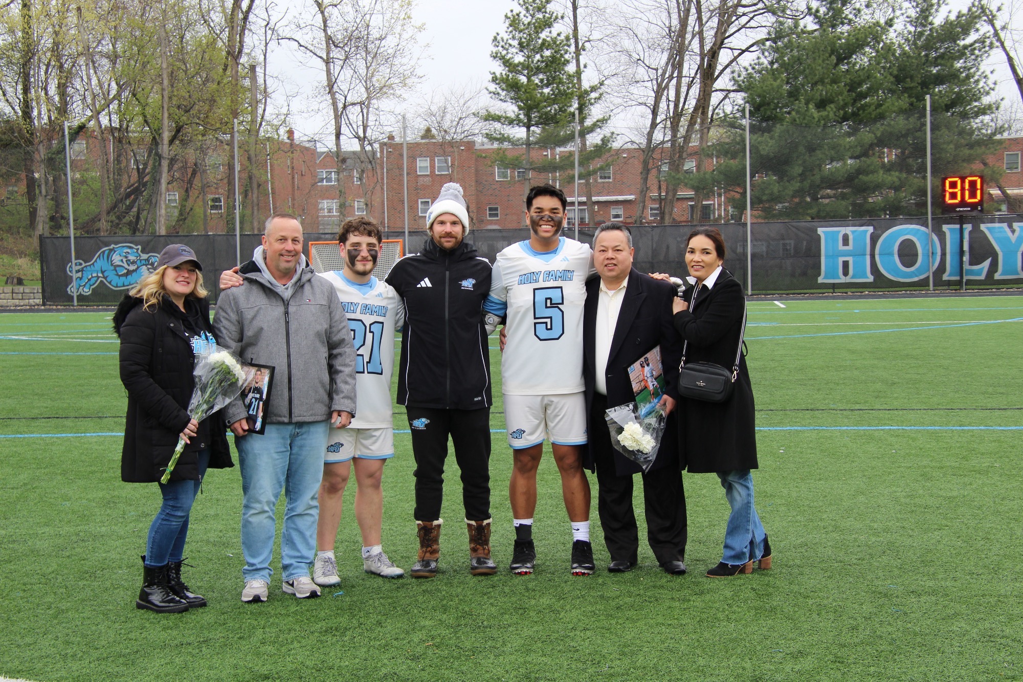 Head Men's Lacrosse Noah Morris and seniors Timmy Tran and Daniel Fierimonte with their families