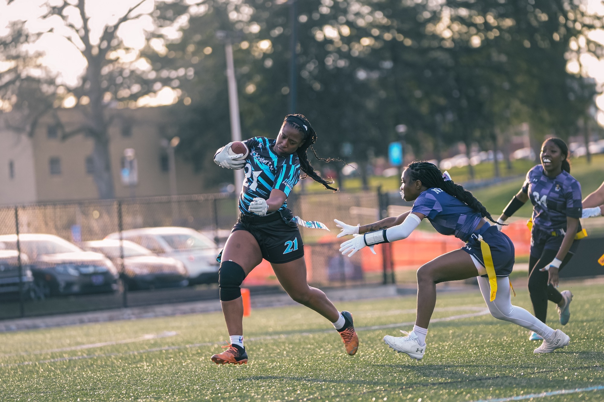 Aleyandra Bartley evades a tackler with the ball in her right hand
