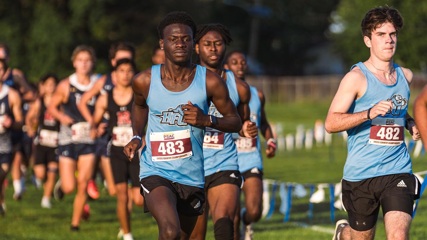 Three members of HFU men's cross country running at the 2025 Herb Lorenz Invitational