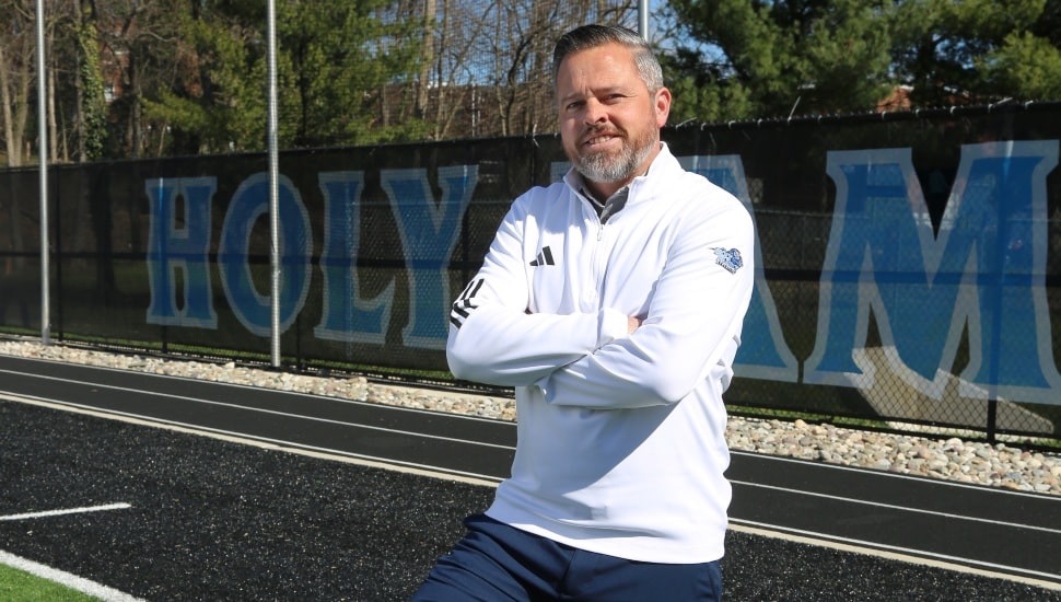 HFU Athletic Director Tim Hamill, wearing a white pullover, poses on Tiger Field