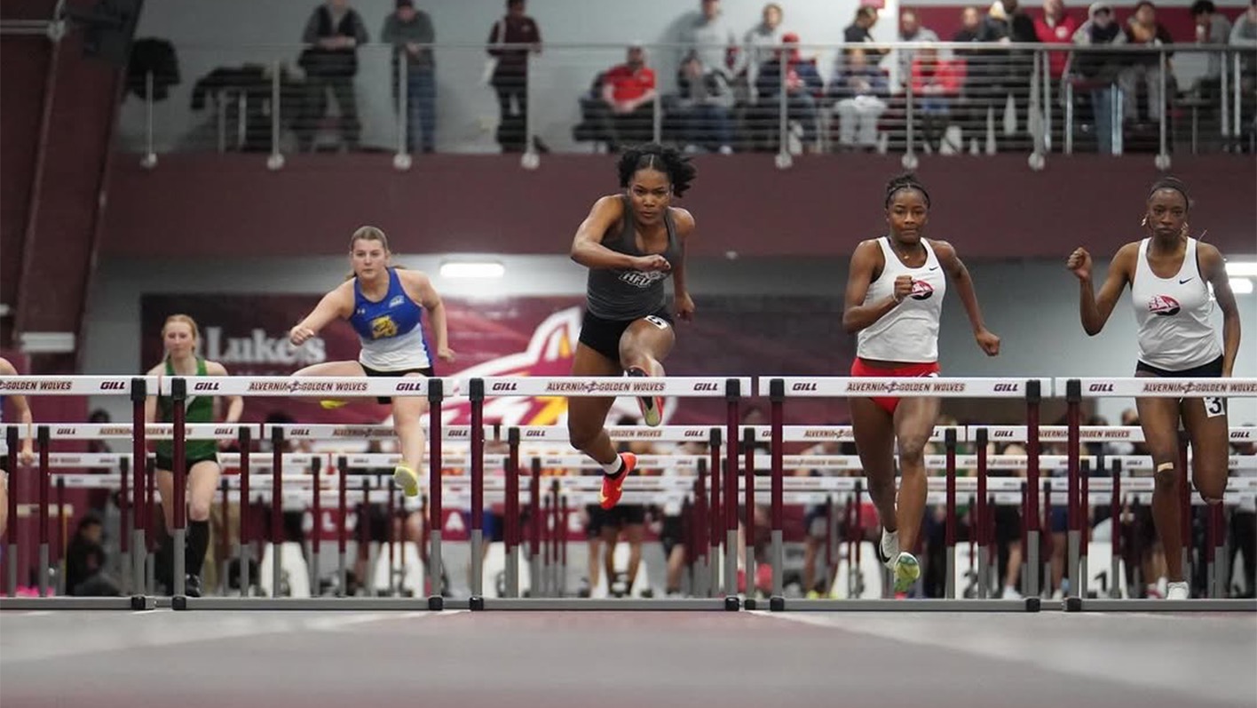 Ocelia Jones jumping over a hurdle